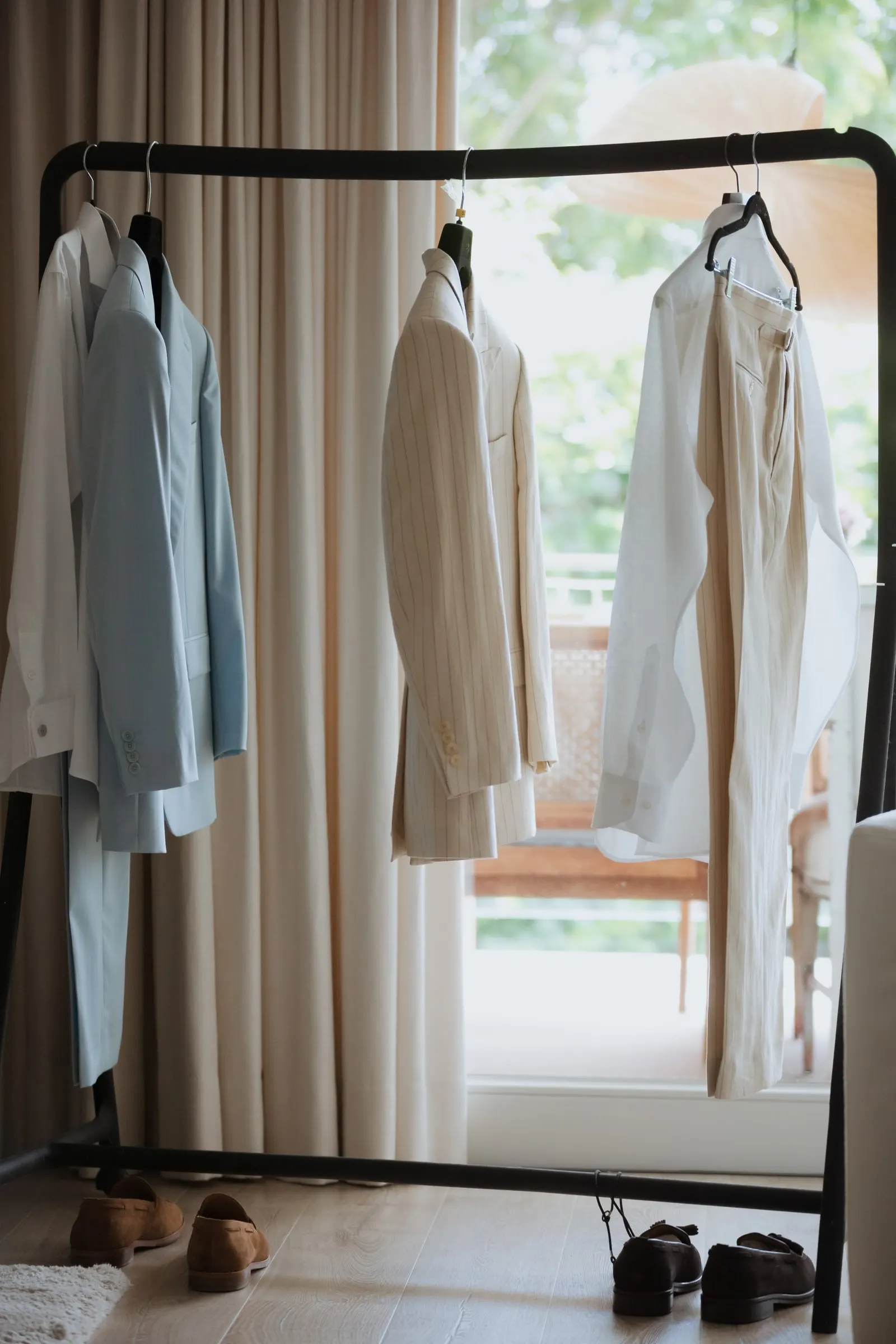 Clothes rail with the groom's light suits and shoes before the wedding, Barbillón, Marbella