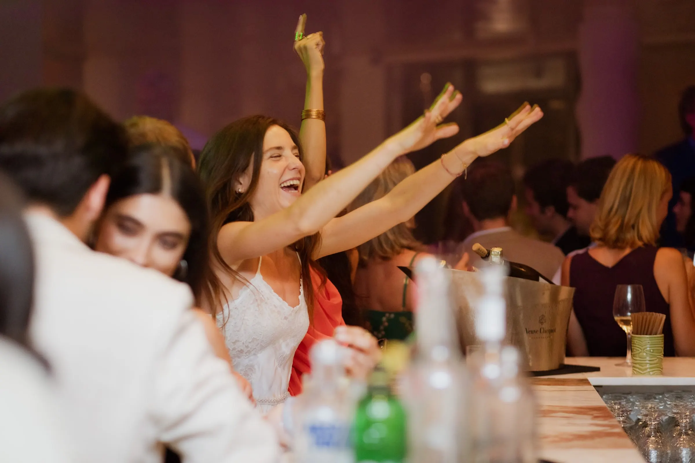 Bride celebrating with both arms in the air at the bar, Barbillón, Marbella
