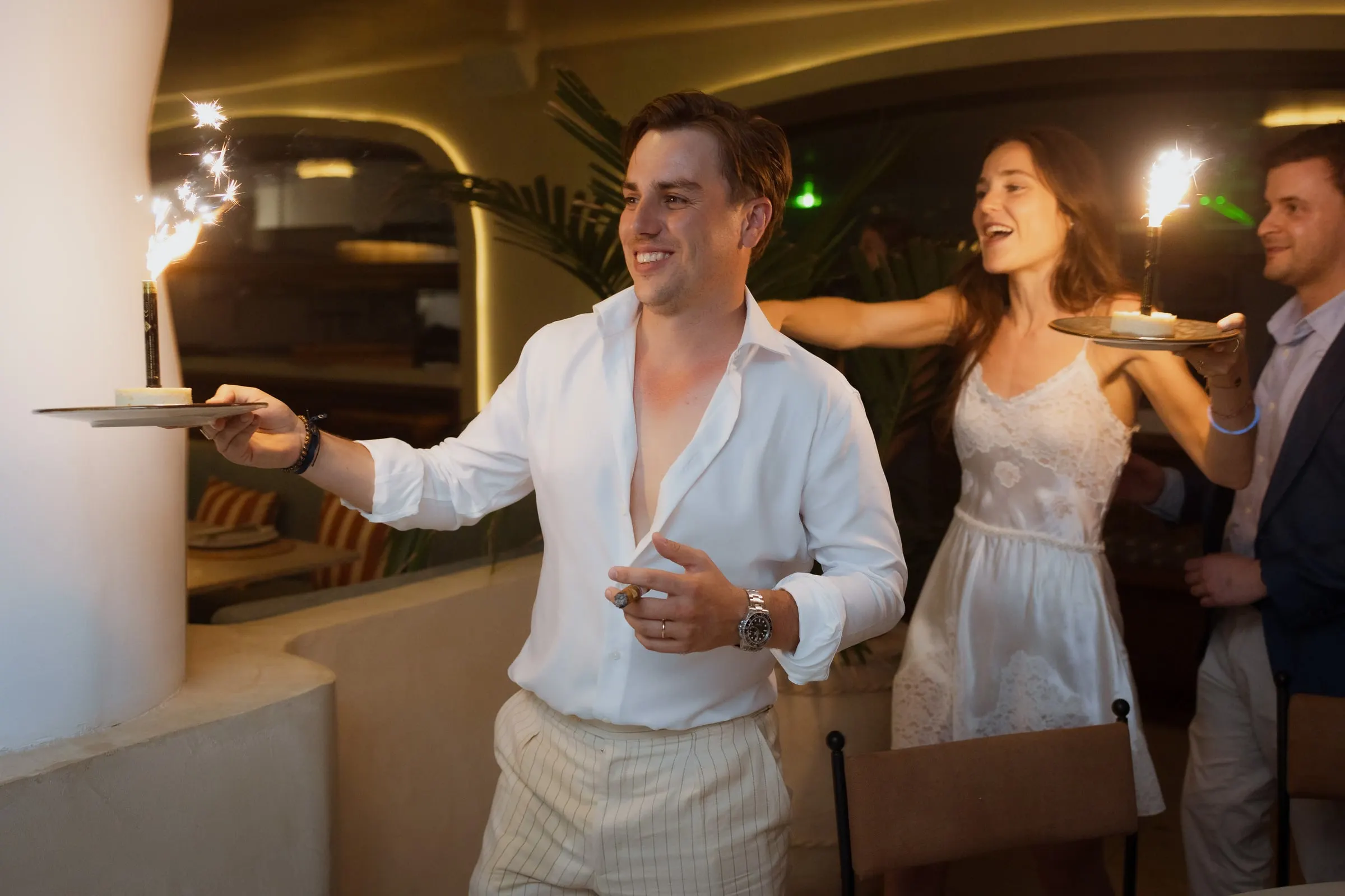 Bride and groom carrying plates with sparklers through the party, Barbillón, Marbella