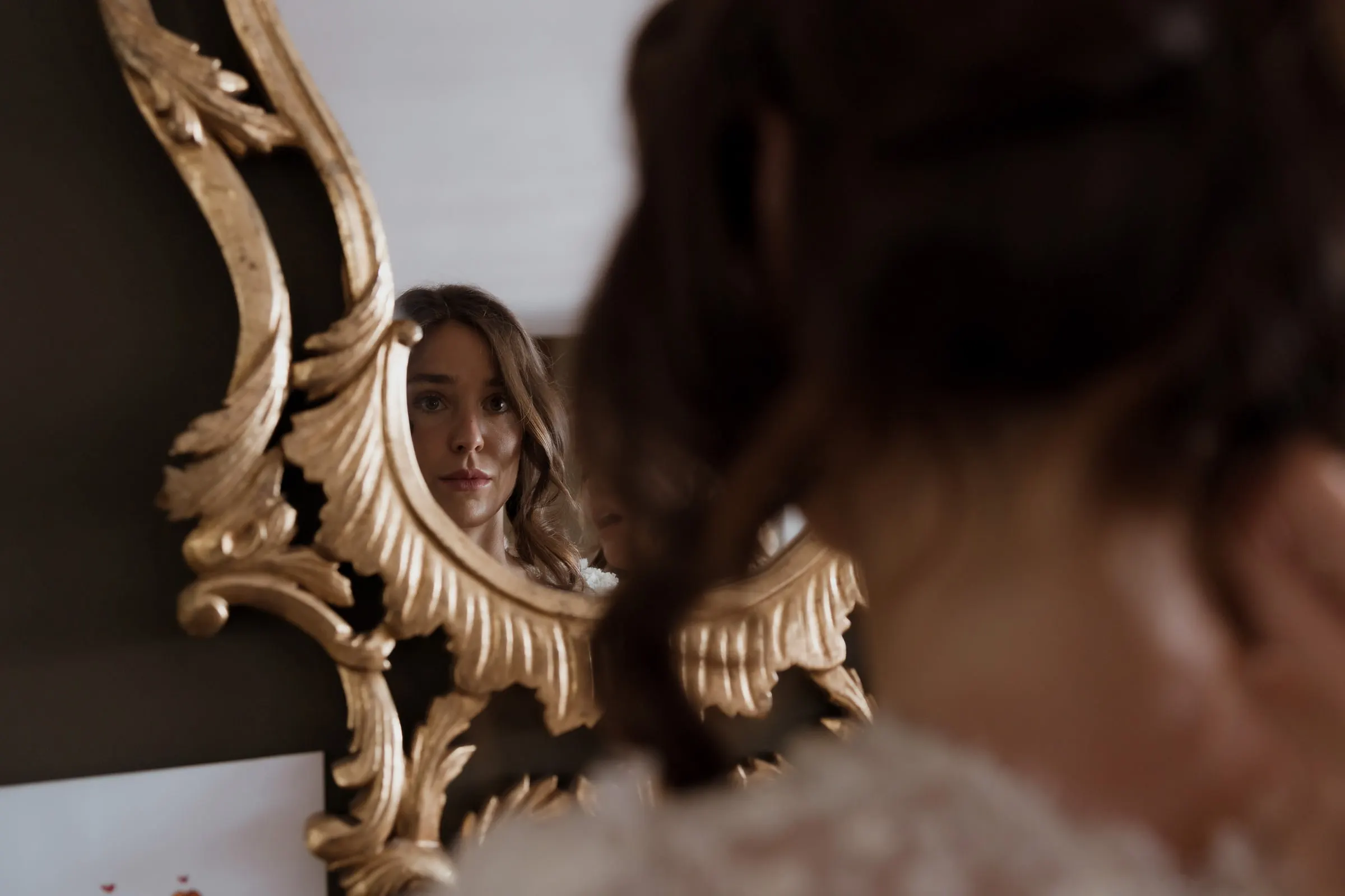 Bride reflected in an ornate gilded mirror while getting ready, Barbillón, Marbella