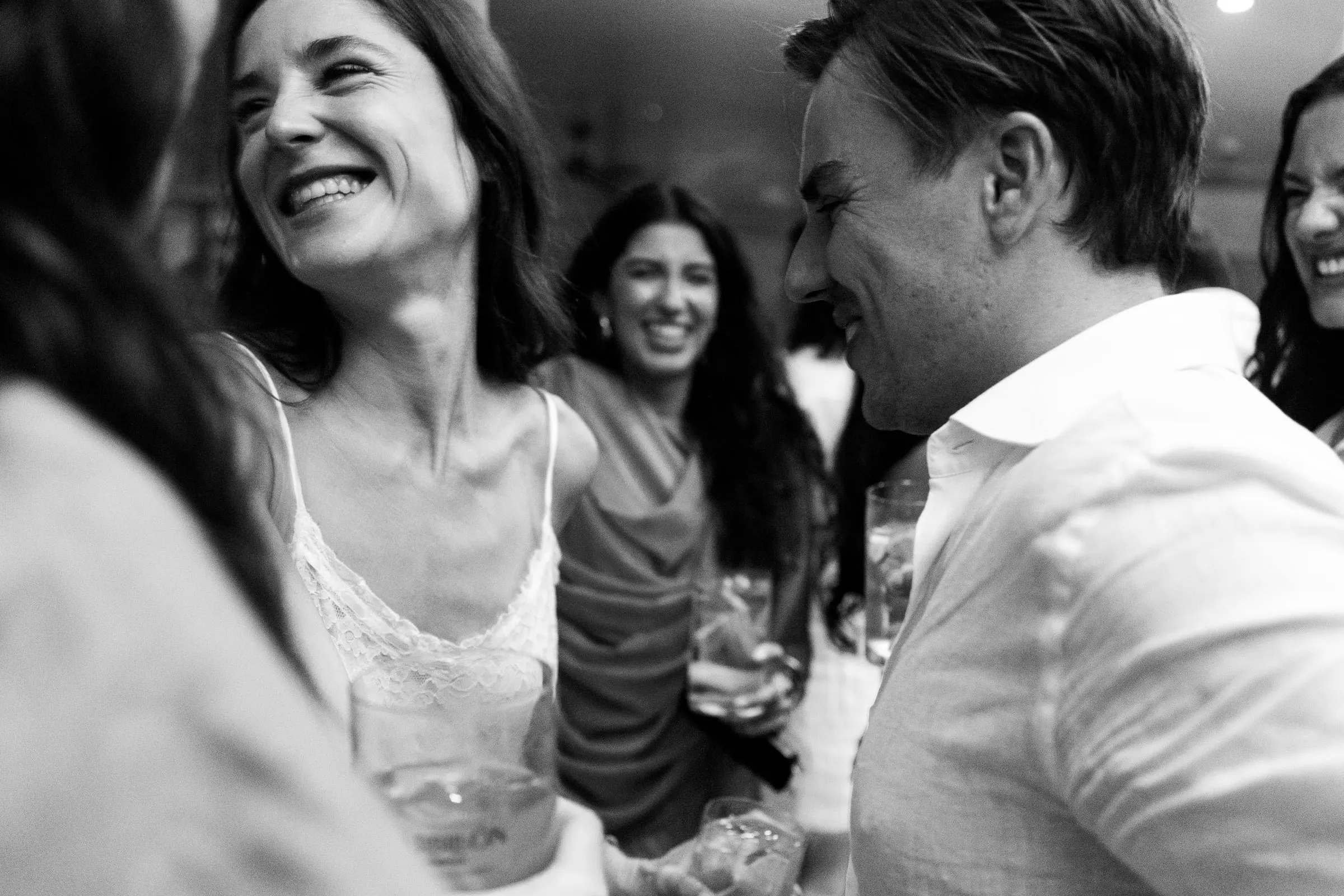 Black and white of the bride laughing with the groom and guests, Barbillón, Marbella
