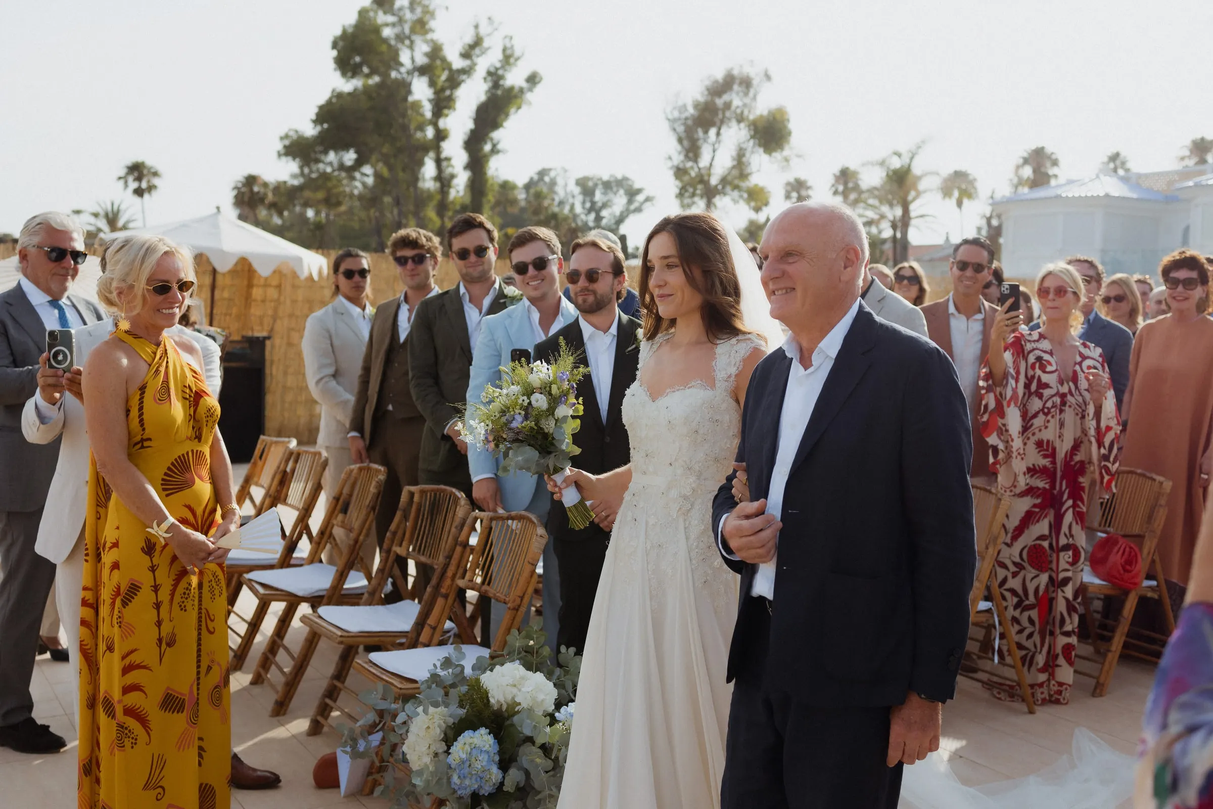 Bride on her father's arm at the top of the aisle as guests watch, Barbillón, Marbella