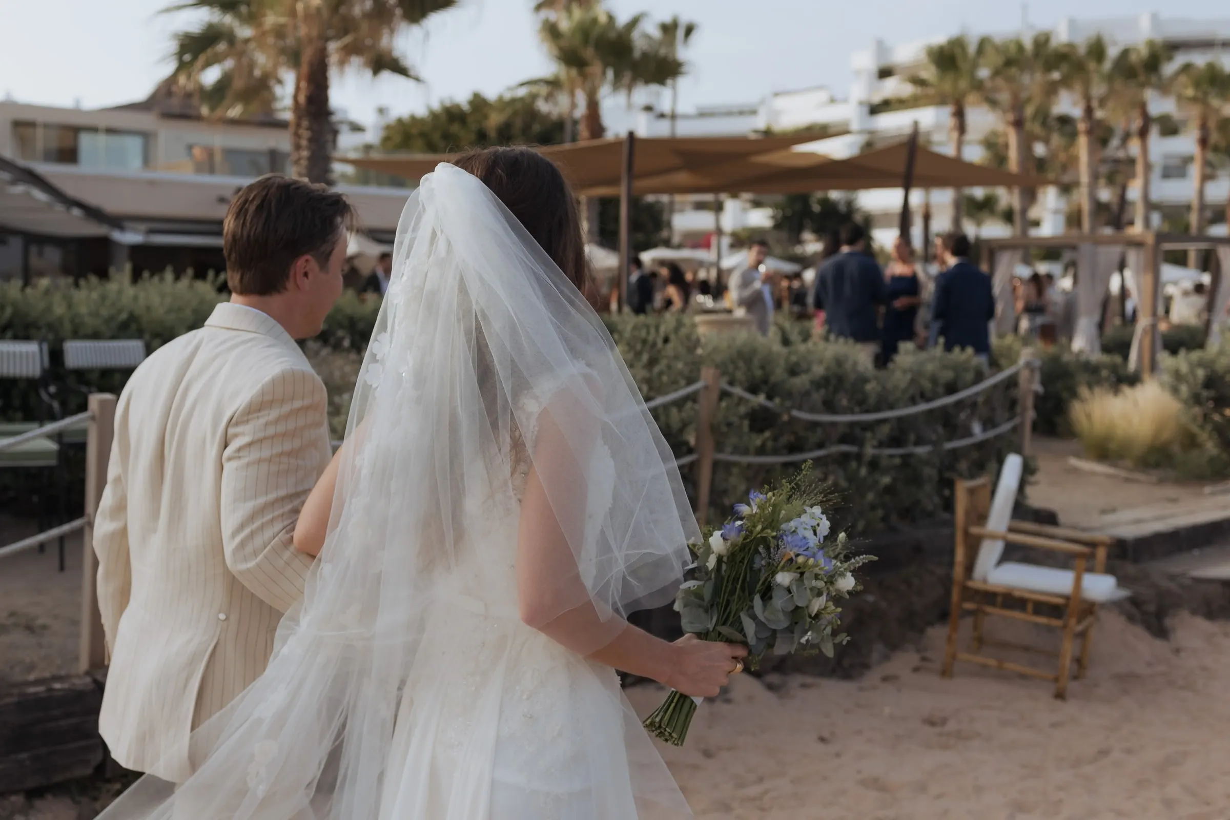 Couple walking across the sand towards the beach club, seen from behind, Barbillón, Marbella