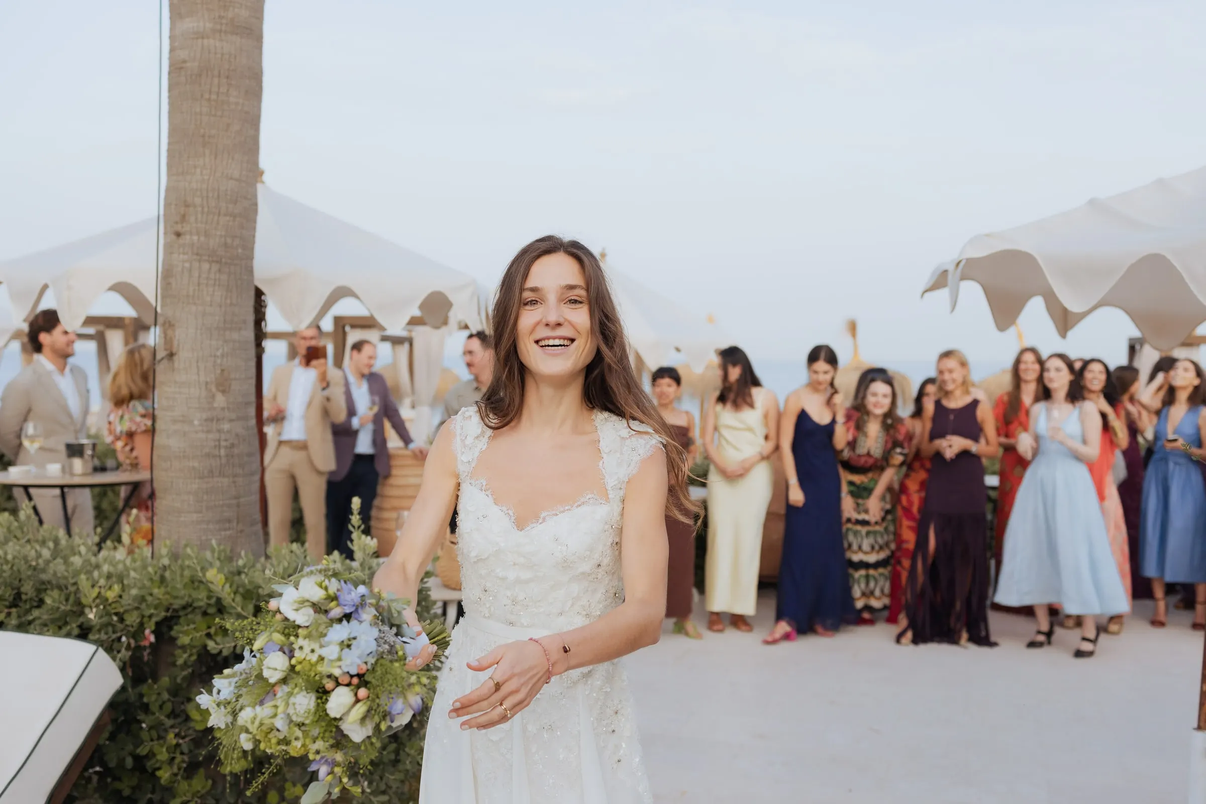 Bride smiling before tossing her bouquet to the women waiting behind, Barbillón, Marbella