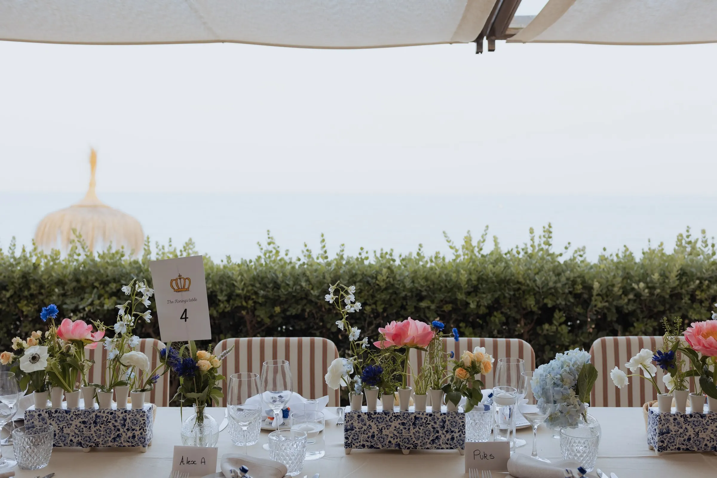 Table with blue and white ceramic planters and flowers facing the sea, Barbillón, Marbella