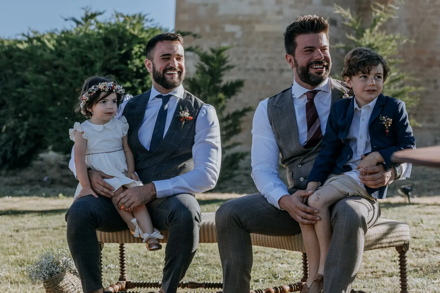 The grooms seated at the ceremony with a child on each lap, Salamanca
