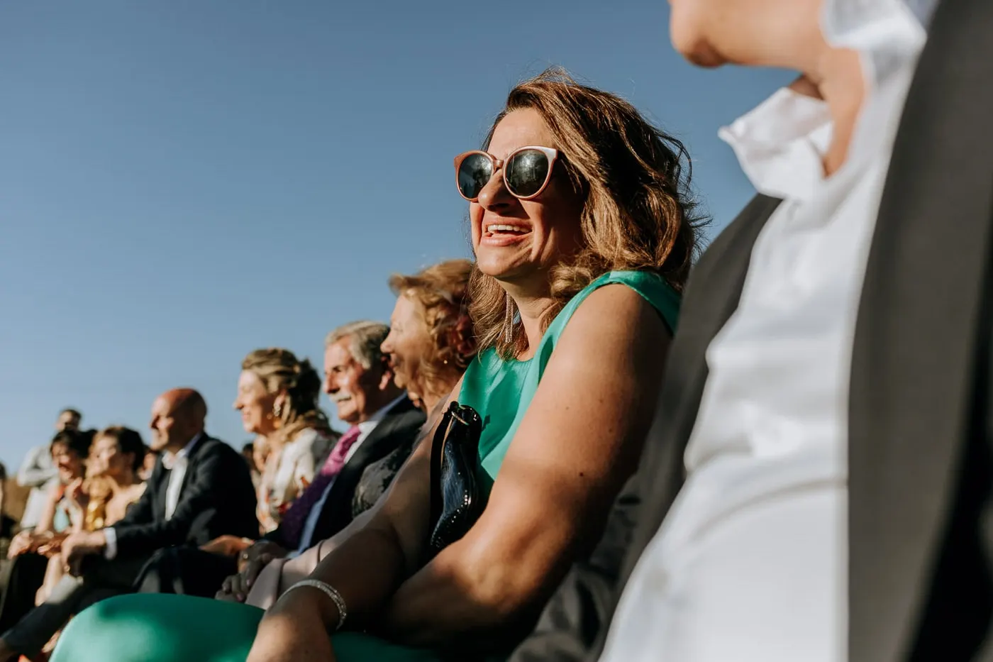 Guest laughing in the front row in the sunshine, Castillo del Buen Amor