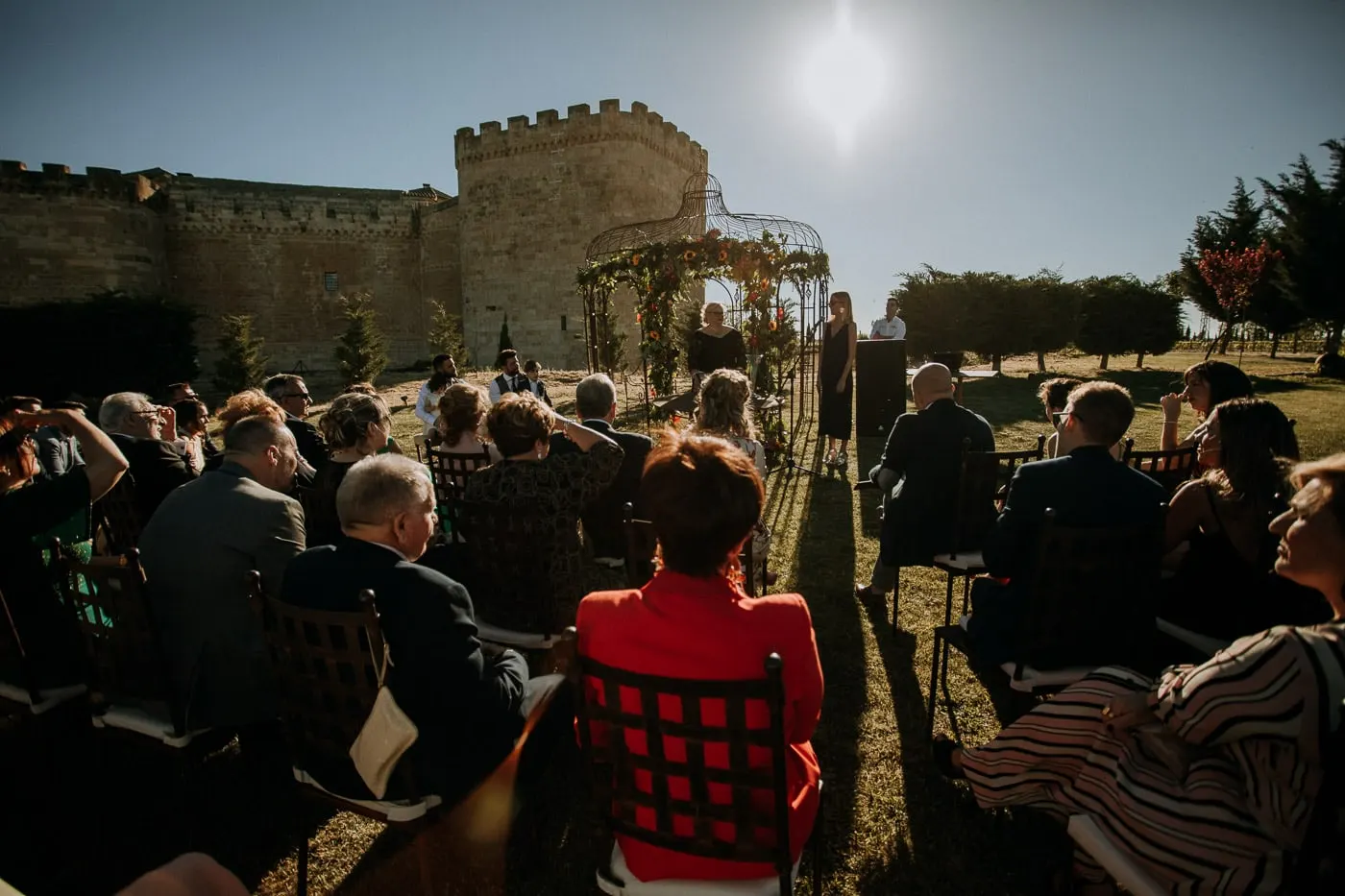 Guests seen from behind facing the gazebo and the castle walls, Salamanca