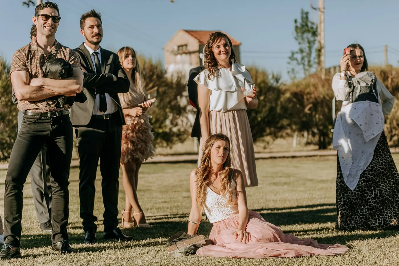 Guests standing and sitting on the lawn during the ceremony, Salamanca