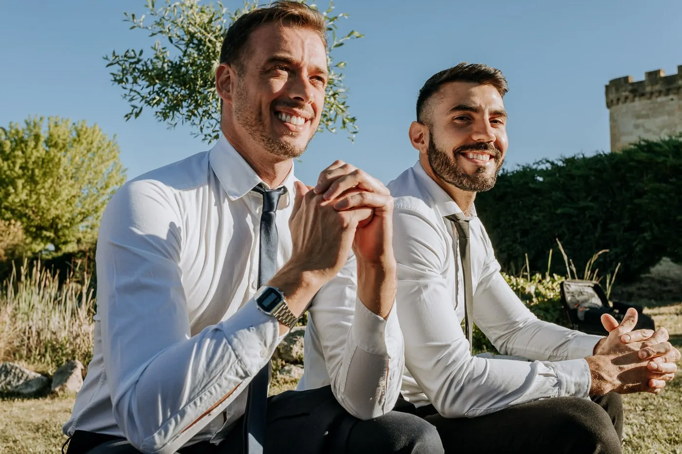 Two friends smiling with their hands clasped during the ceremony, Castillo del Buen Amor
