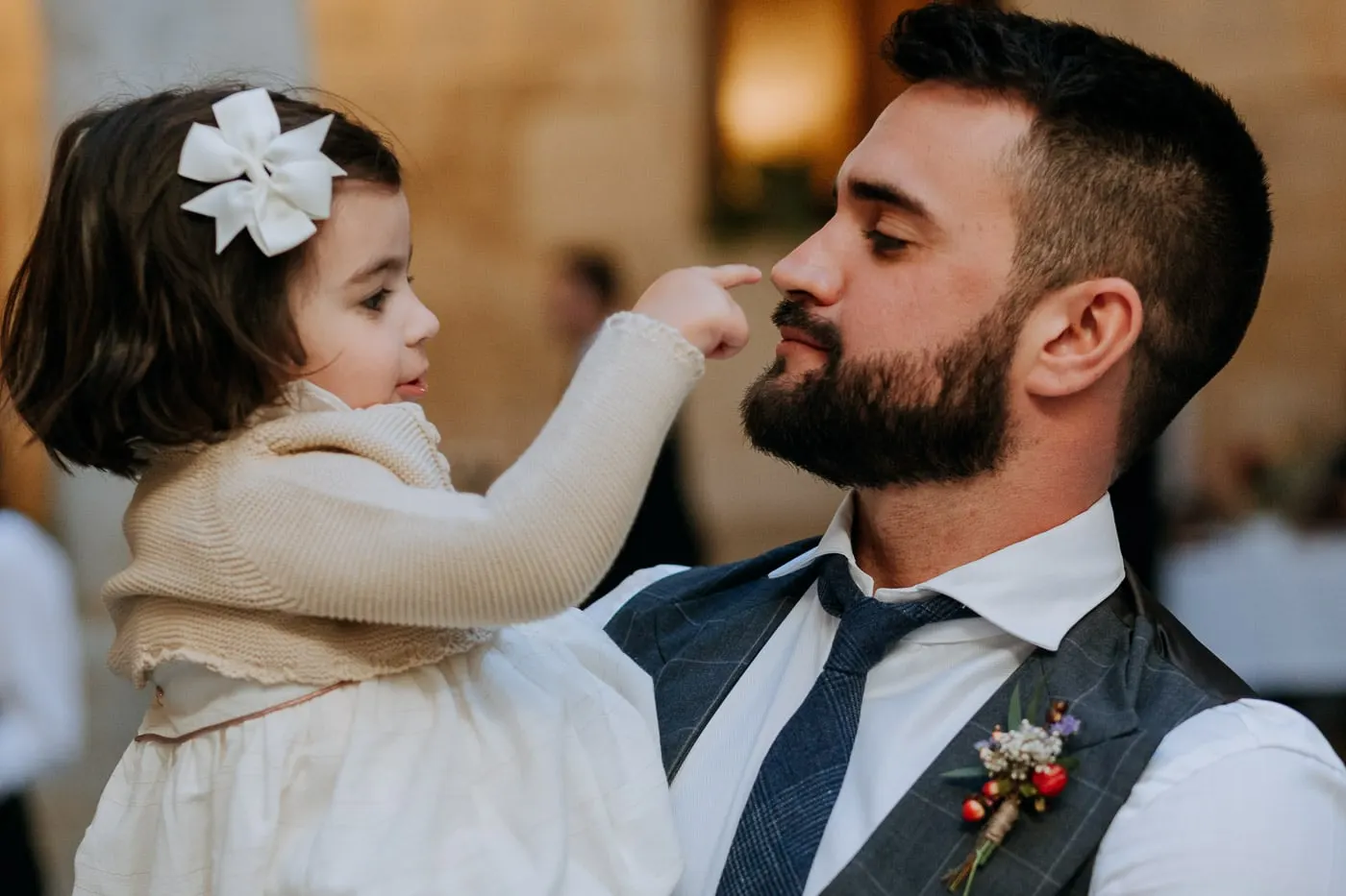 Little girl with a white bow touching the groom's nose, Salamanca