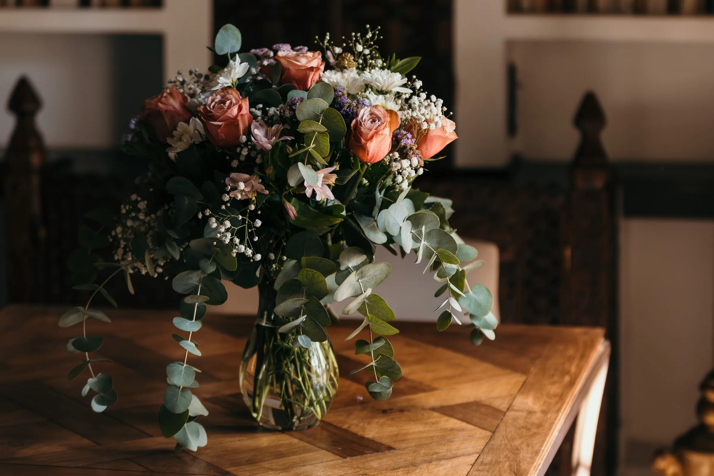 Centrepiece of roses, gypsophila and eucalyptus in a glass vase, Cortijo San Francisco, Estepona