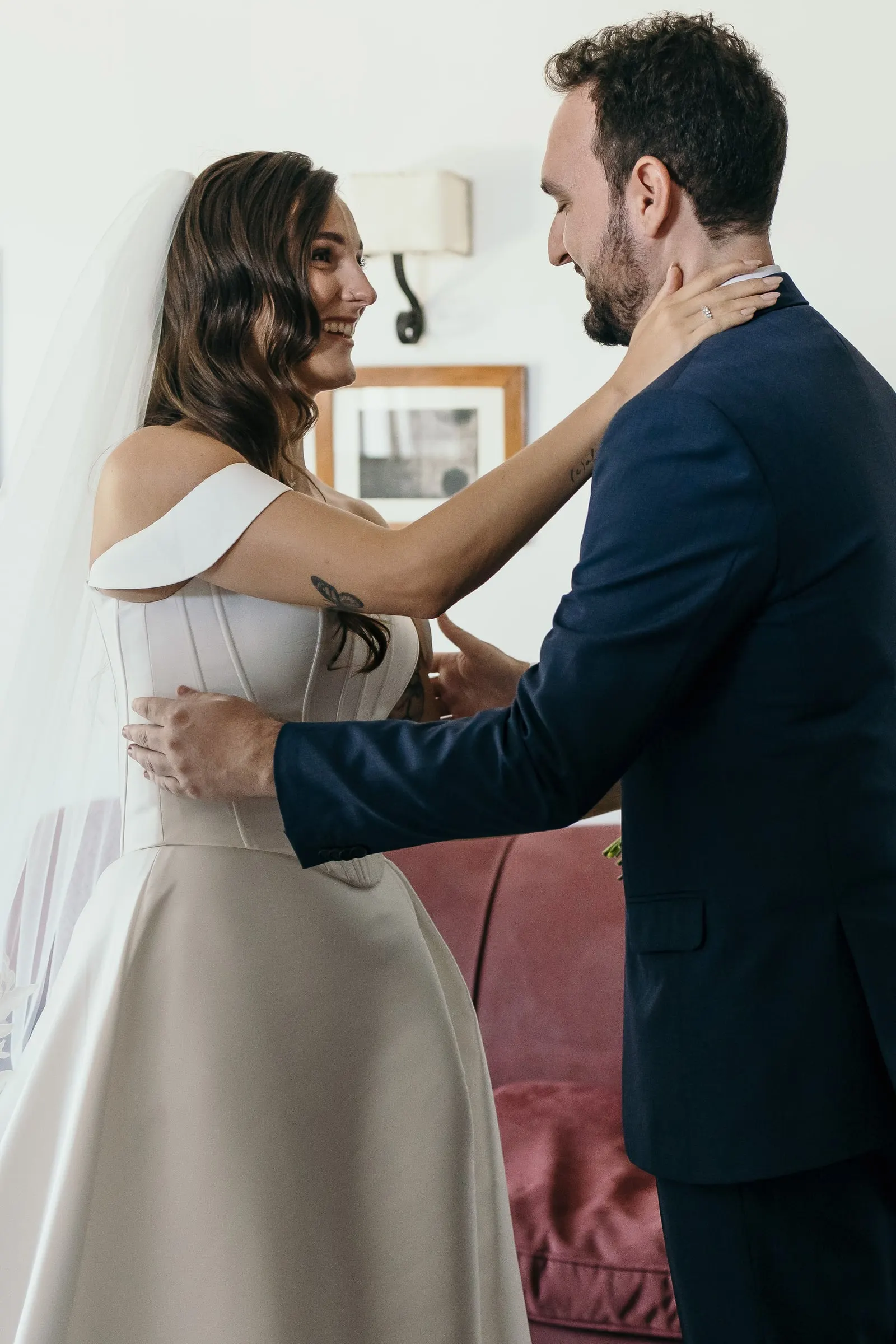 Bride touching the groom's face during their first look inside the finca