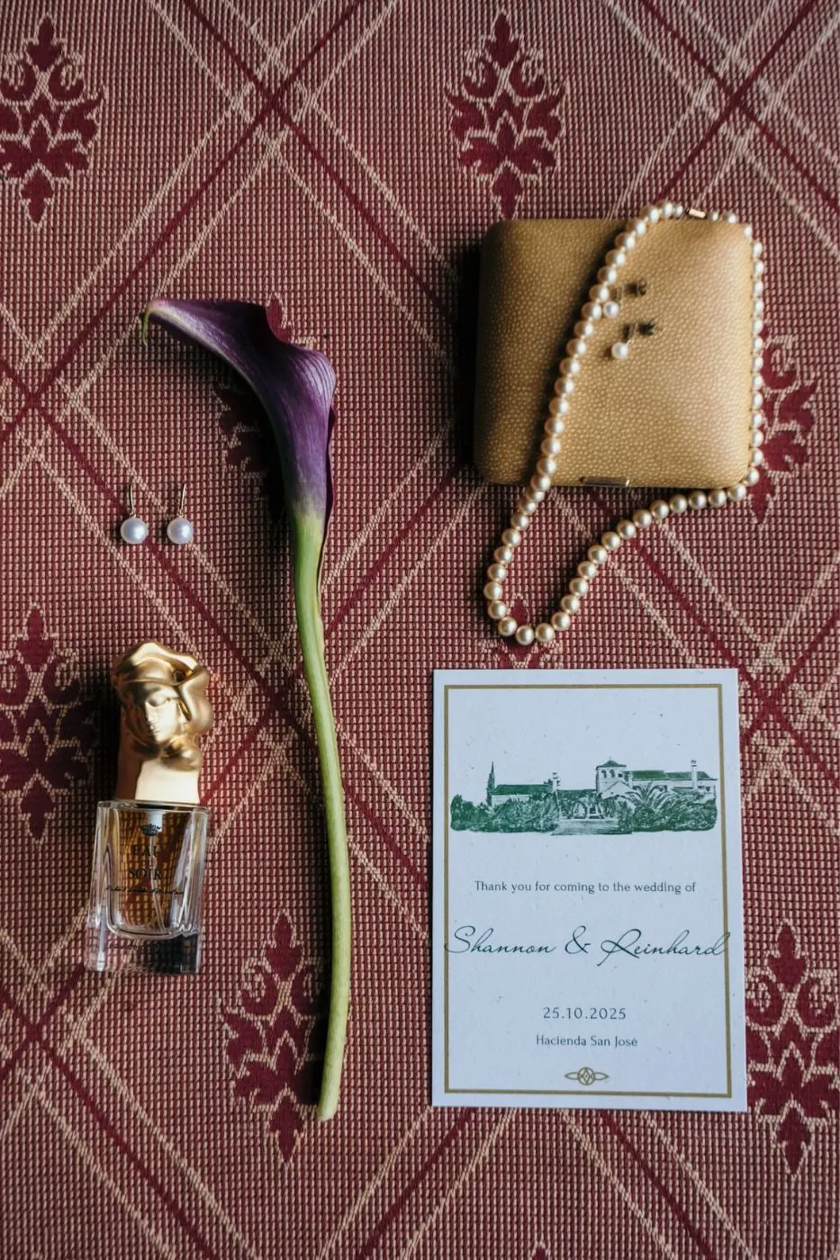 Bridal flat lay with a purple calla lily, pearls, perfume and the wedding invitation, Hacienda San José, Mijas