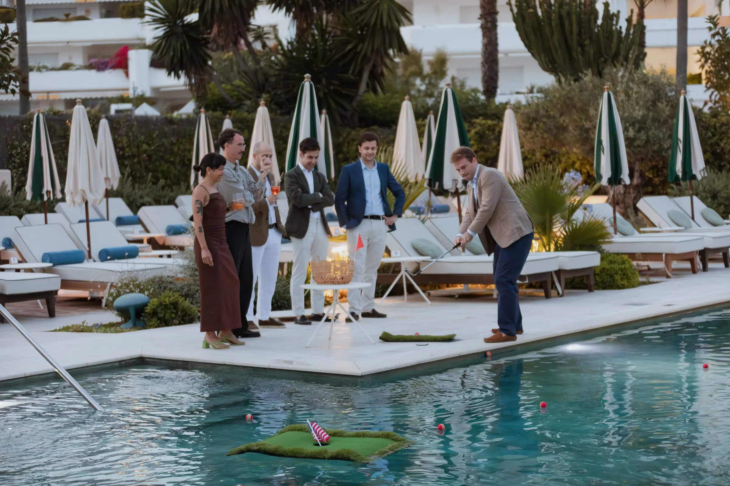 Guest putting a golf ball towards a floating hole in the pool, Barbillón, Marbella