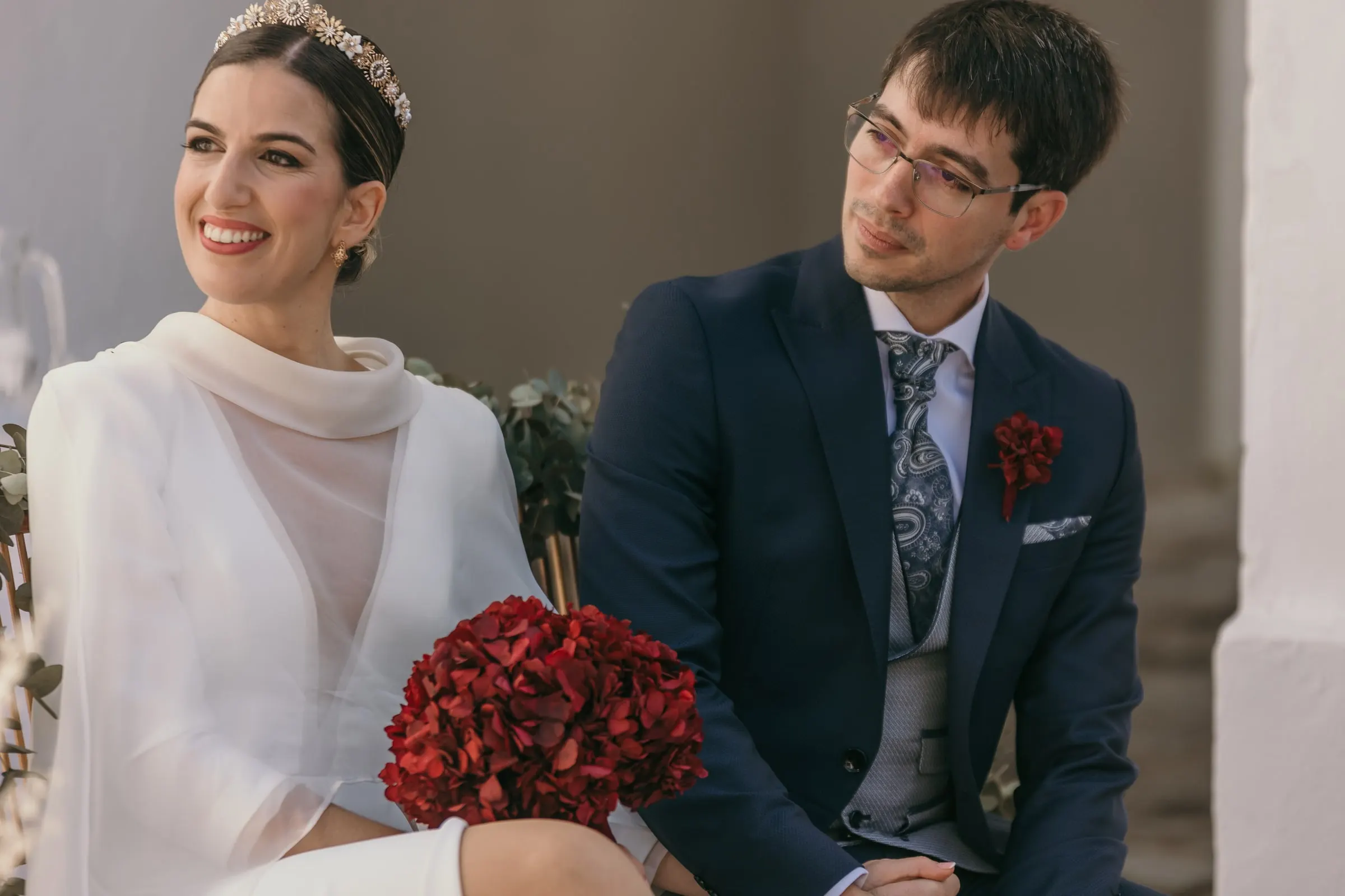 Bride laughing as the groom looks at her during the civil ceremony at the cortijo