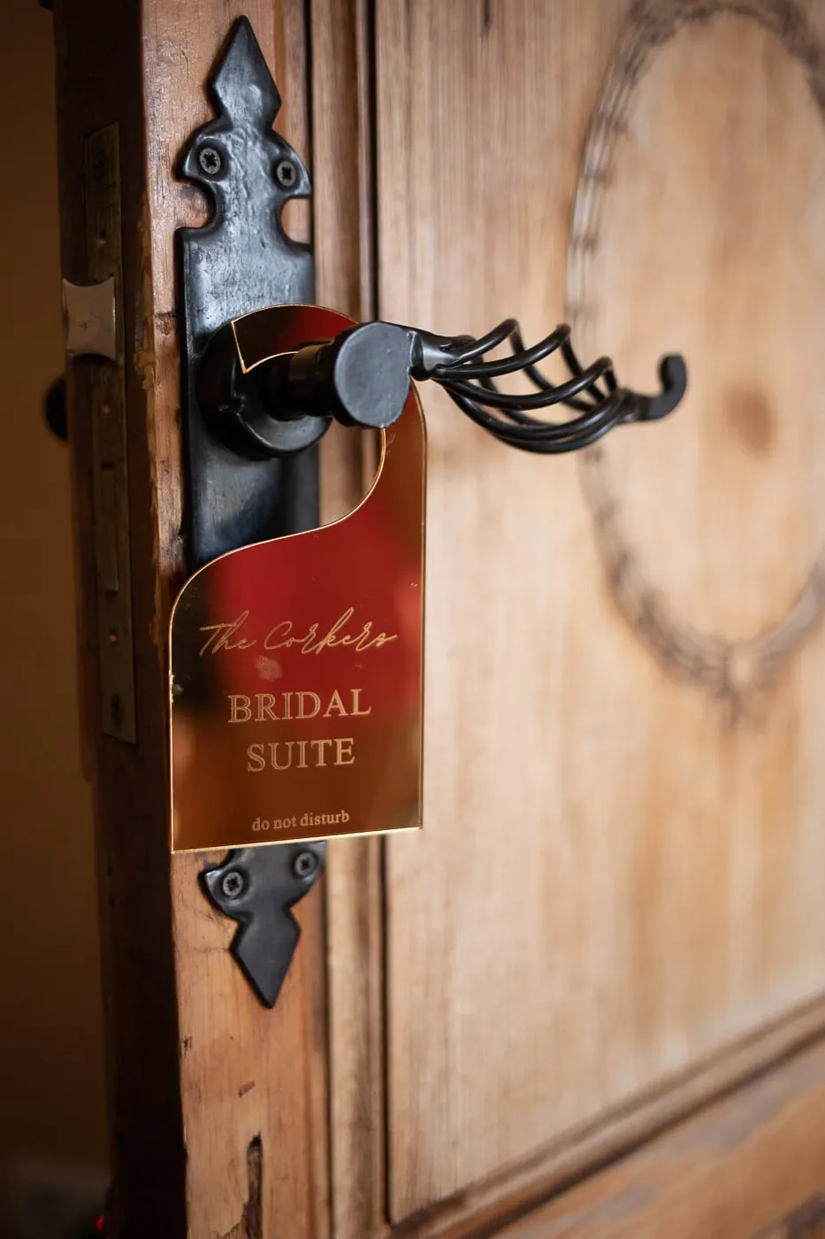 'Bridal Suite' sign hanging from the iron handle of an old wooden door, Hacienda San José, Mijas