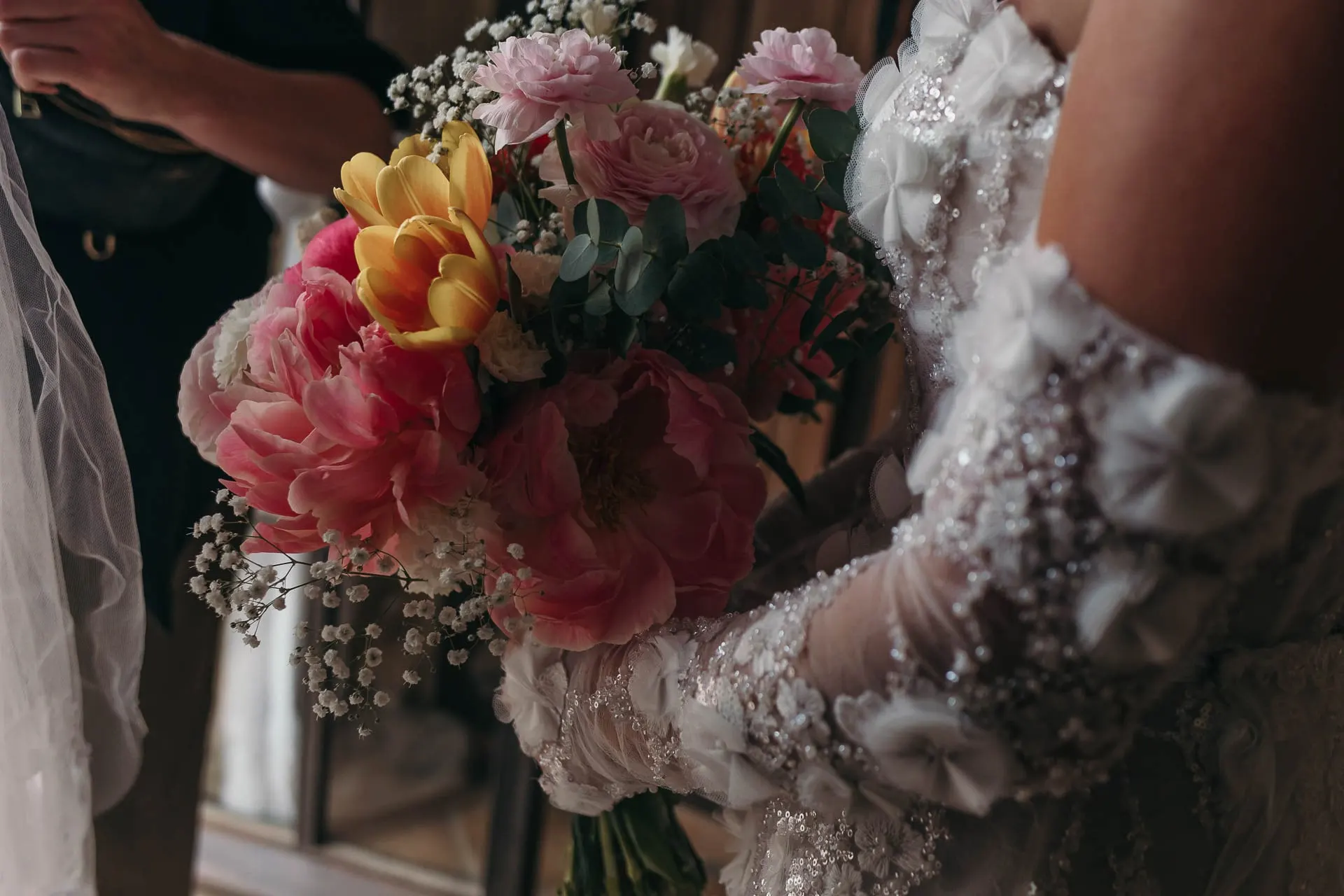 Close-up of the bride's bouquet of peonies, tulips and baby's breath against her lace glove, Hacienda San José, Mijas