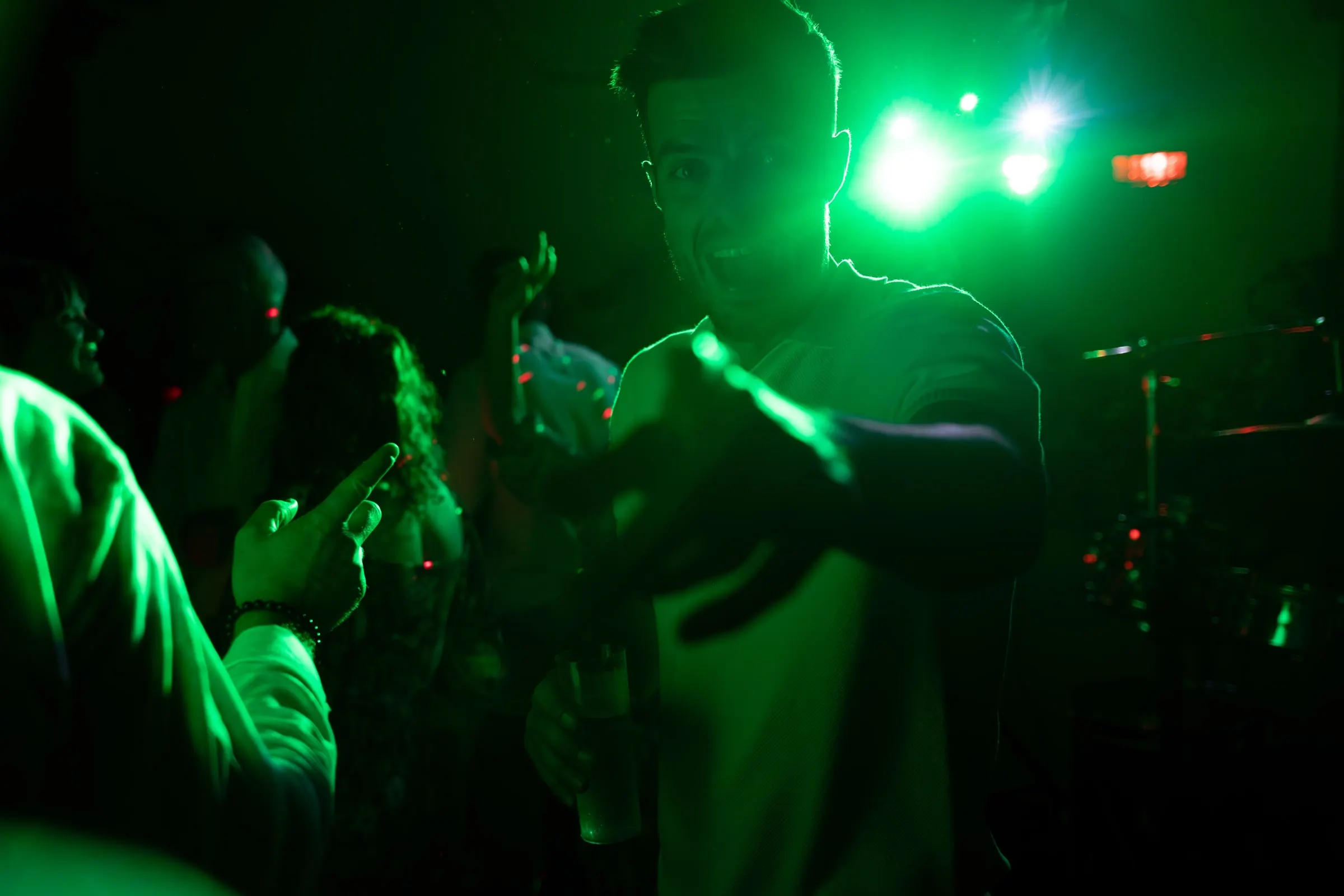 Guests dancing in green light at night, Mijas