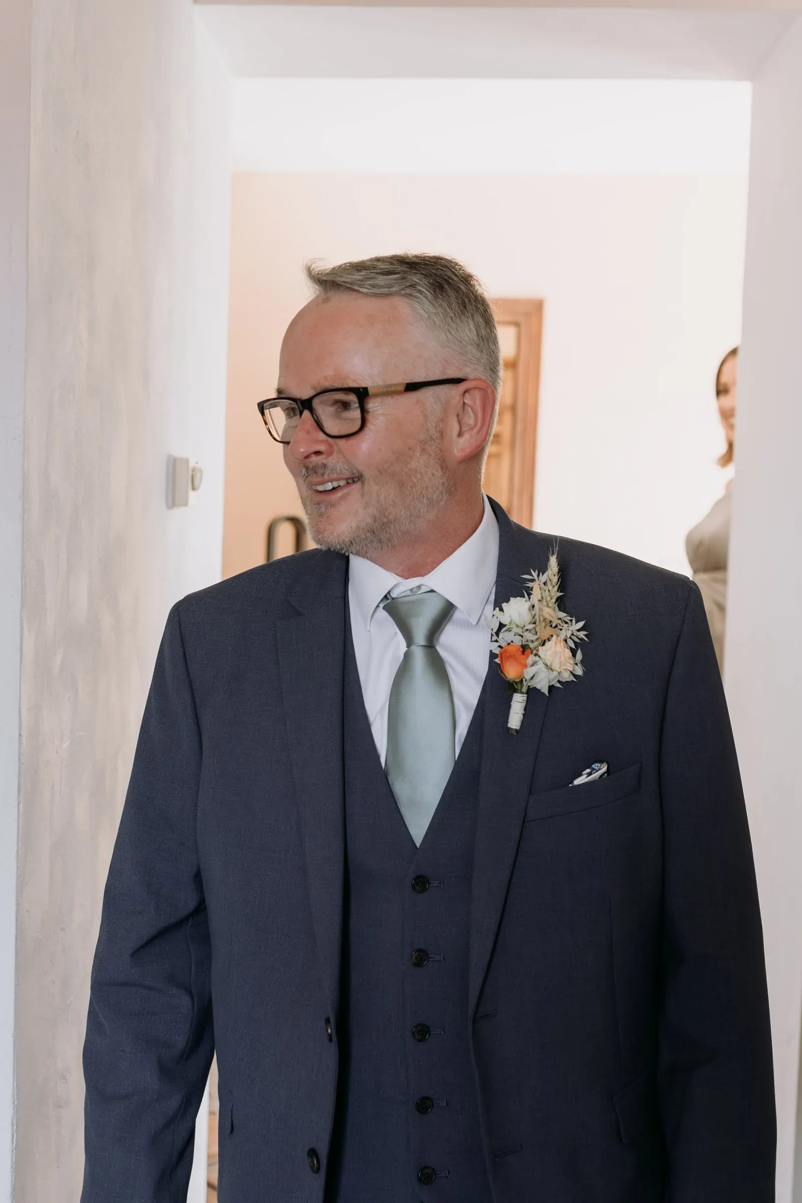 Father of the bride in a navy three-piece suit seeing her in the dress for the first time, Hacienda San José