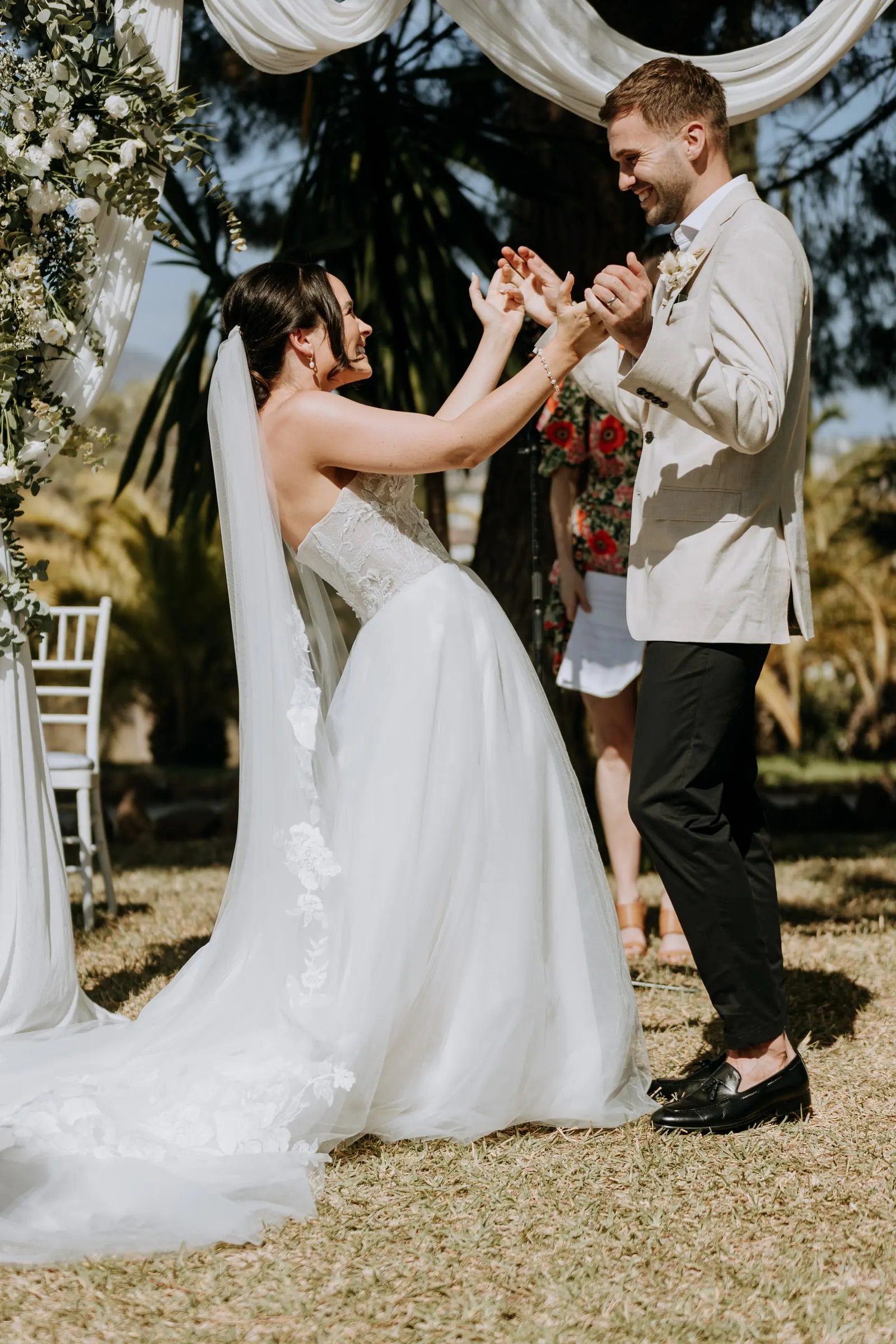 Bride and groom celebrating with raised hands as they are declared married, Hacienda San José