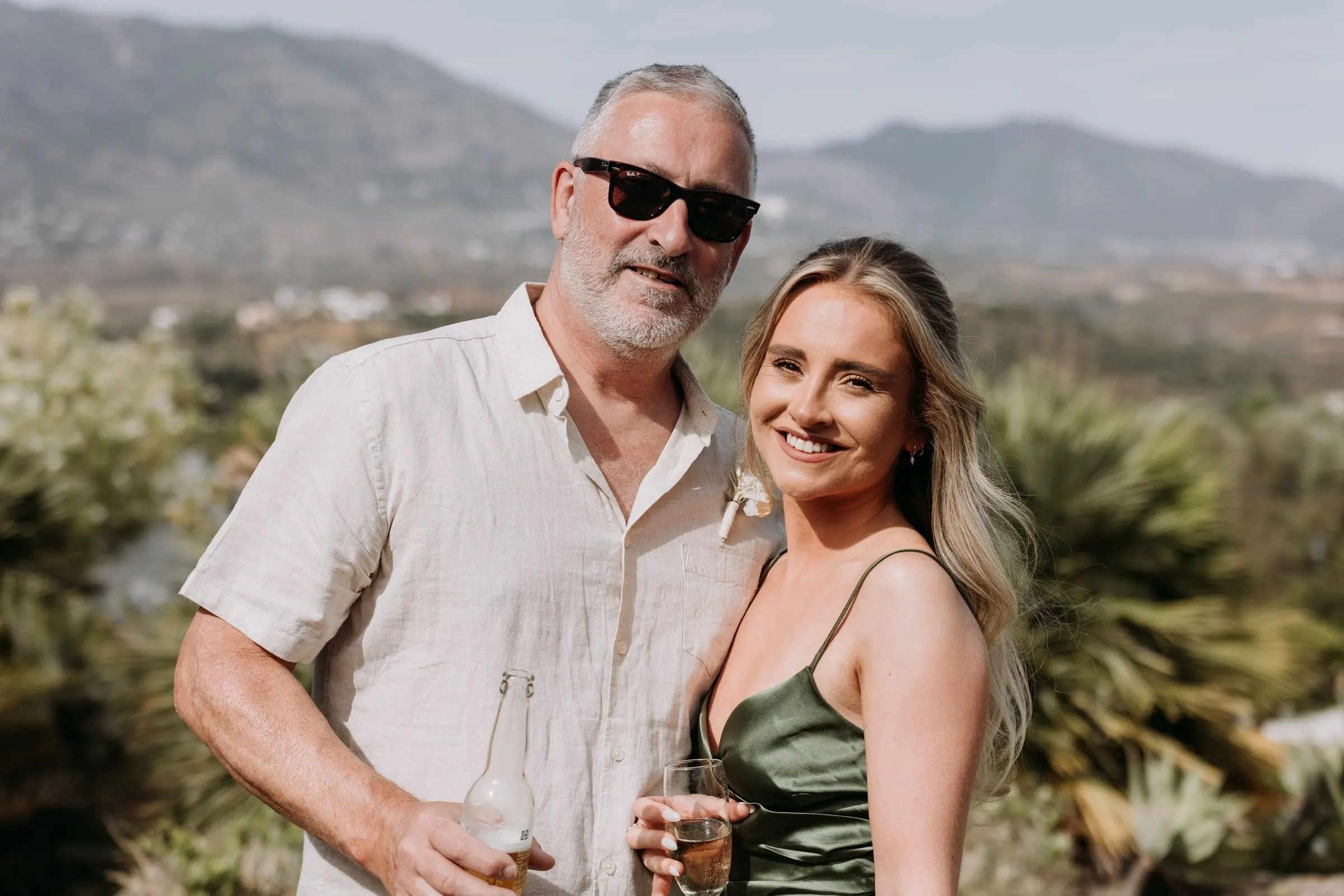 Wedding guests with drinks in front of the Mijas mountains