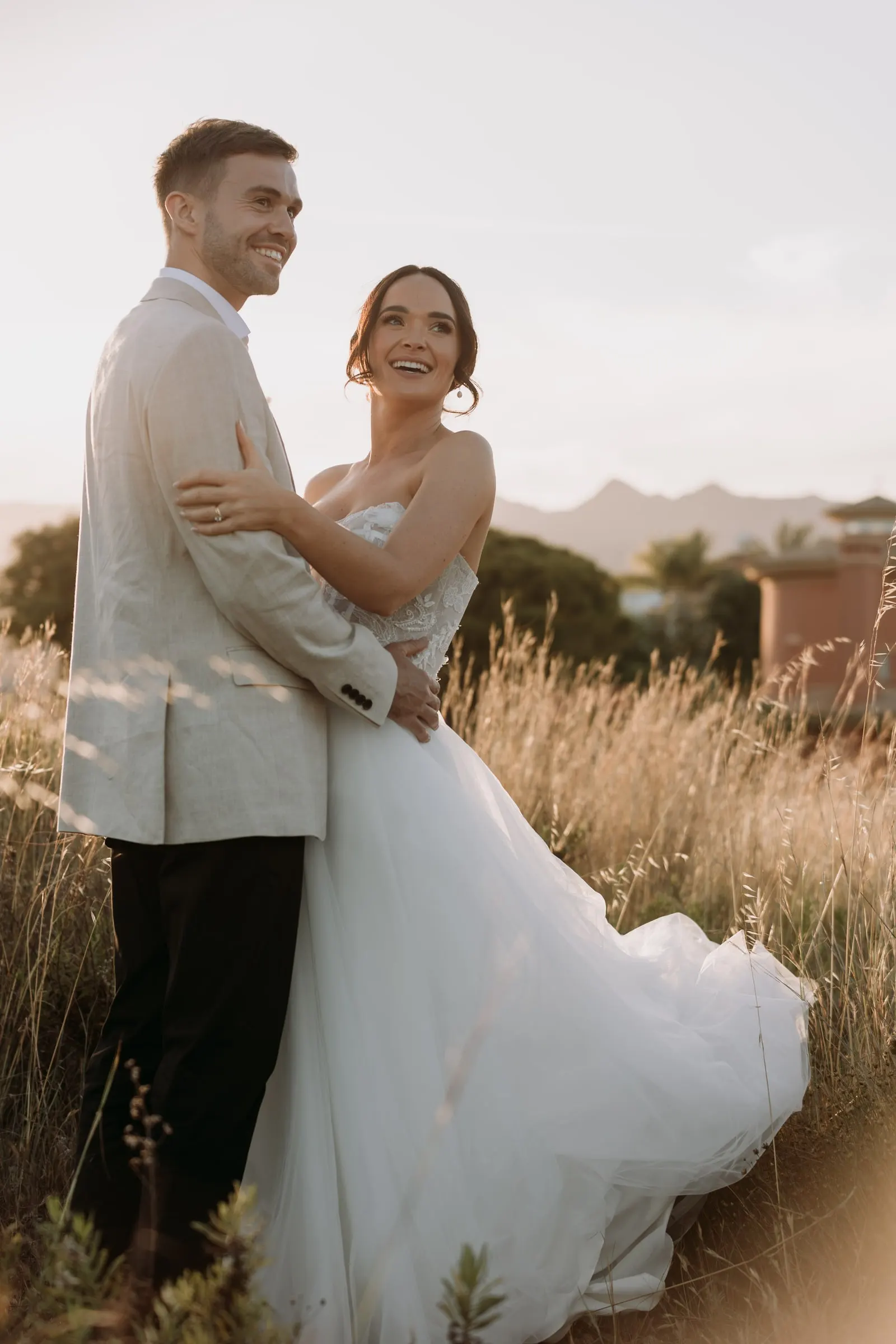 Bride laughing in the groom's arms in the evening light, Mijas