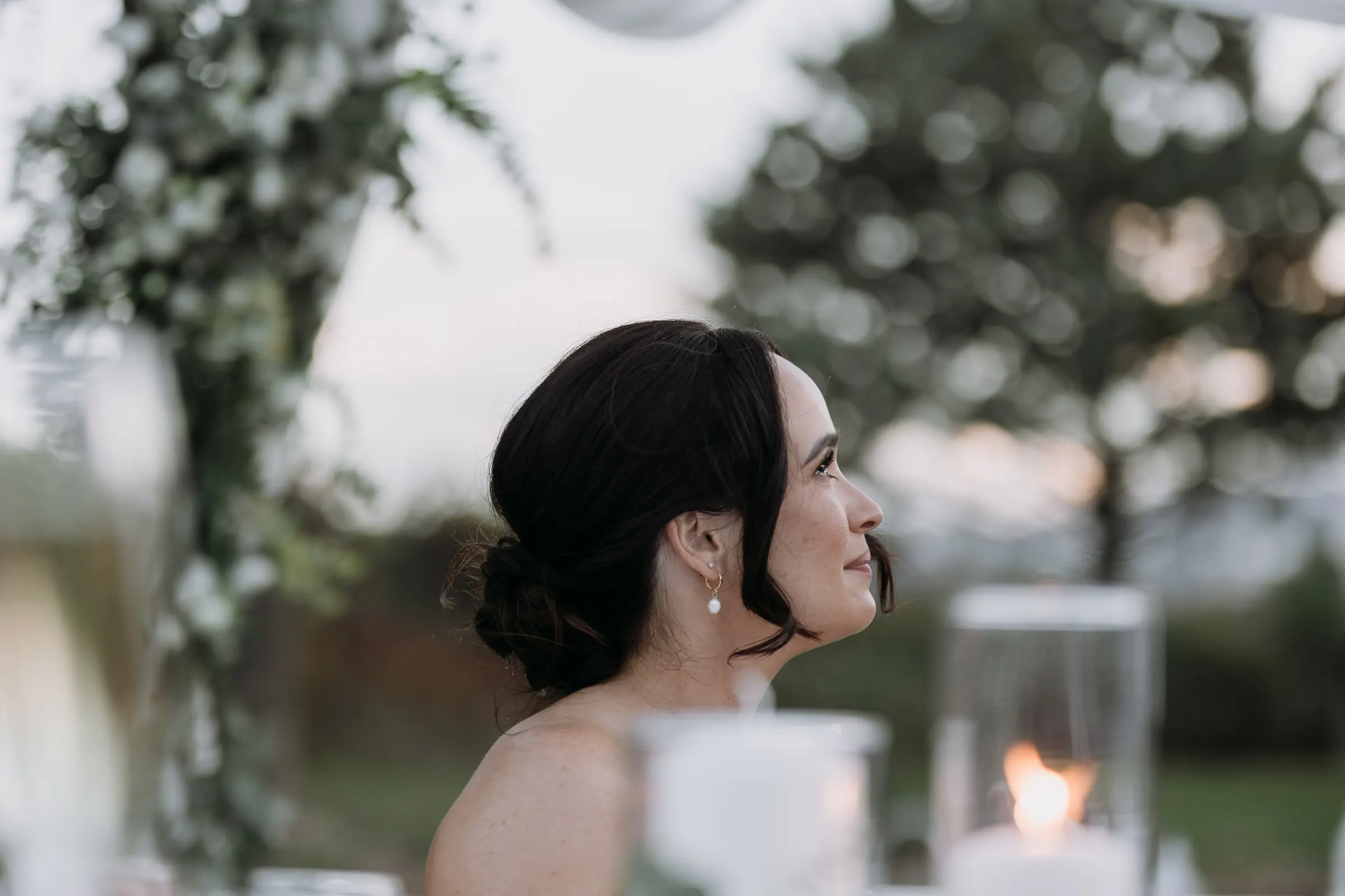 Profile of the bride listening to the speeches by candlelight, Mijas