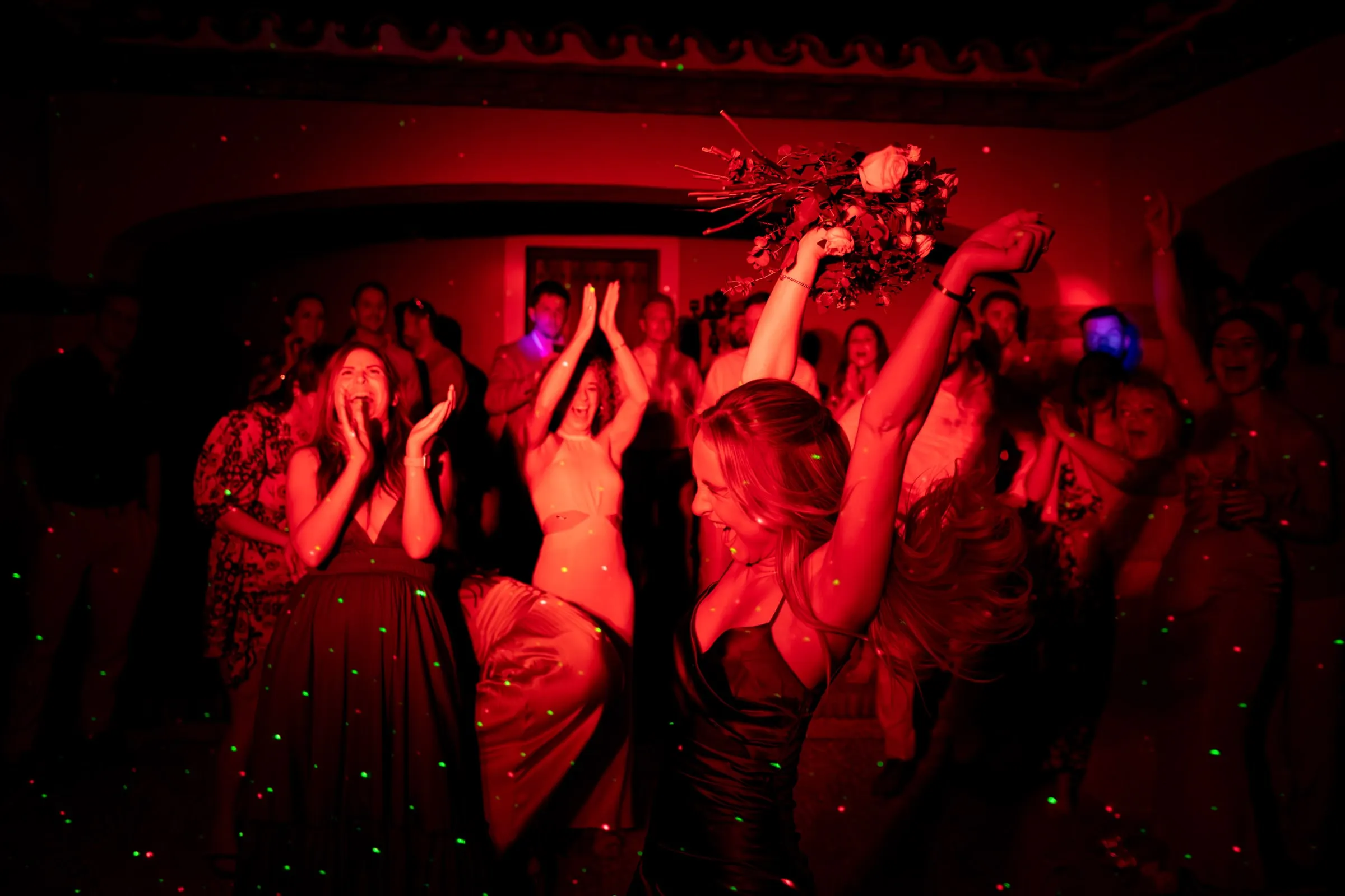 Dance floor glowing red as the bouquet flies over the guests, Mijas