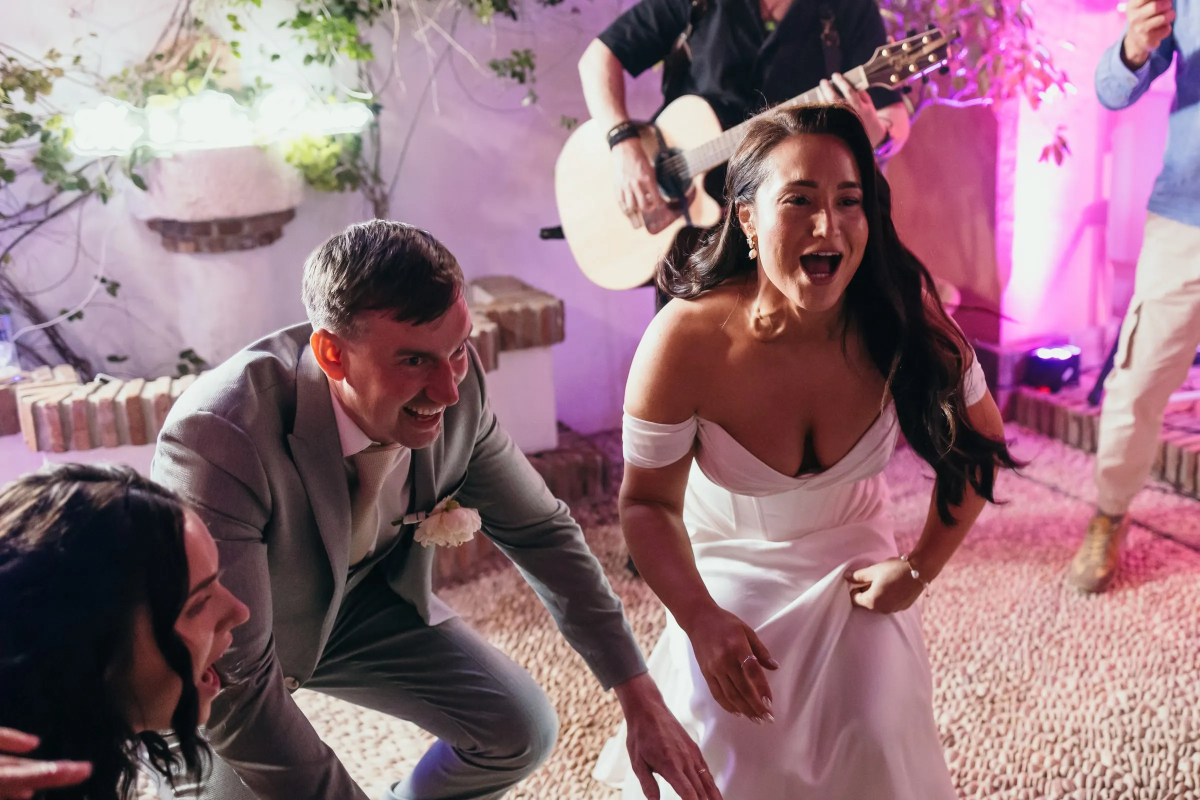 Guitarist of the live band playing as the bride and groom dance in the courtyard, Hacienda San José, Mijas