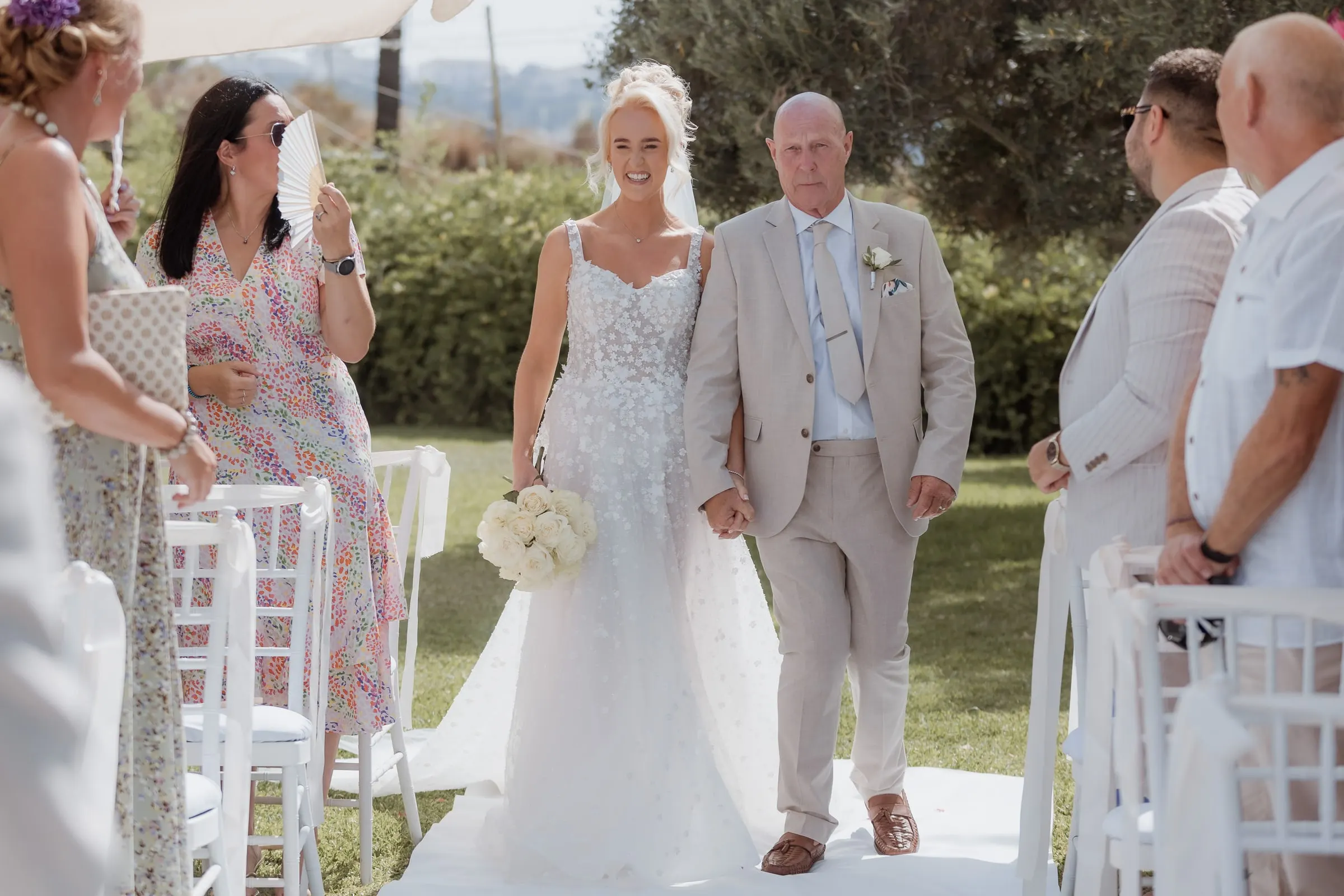 Bride walking down the garden aisle with her father, outdoor ceremony in Mijas