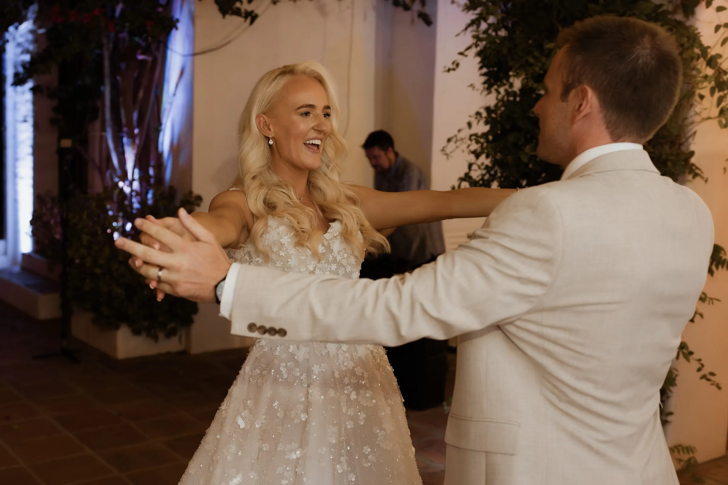 Bride and groom laughing through their first dance in Mijas