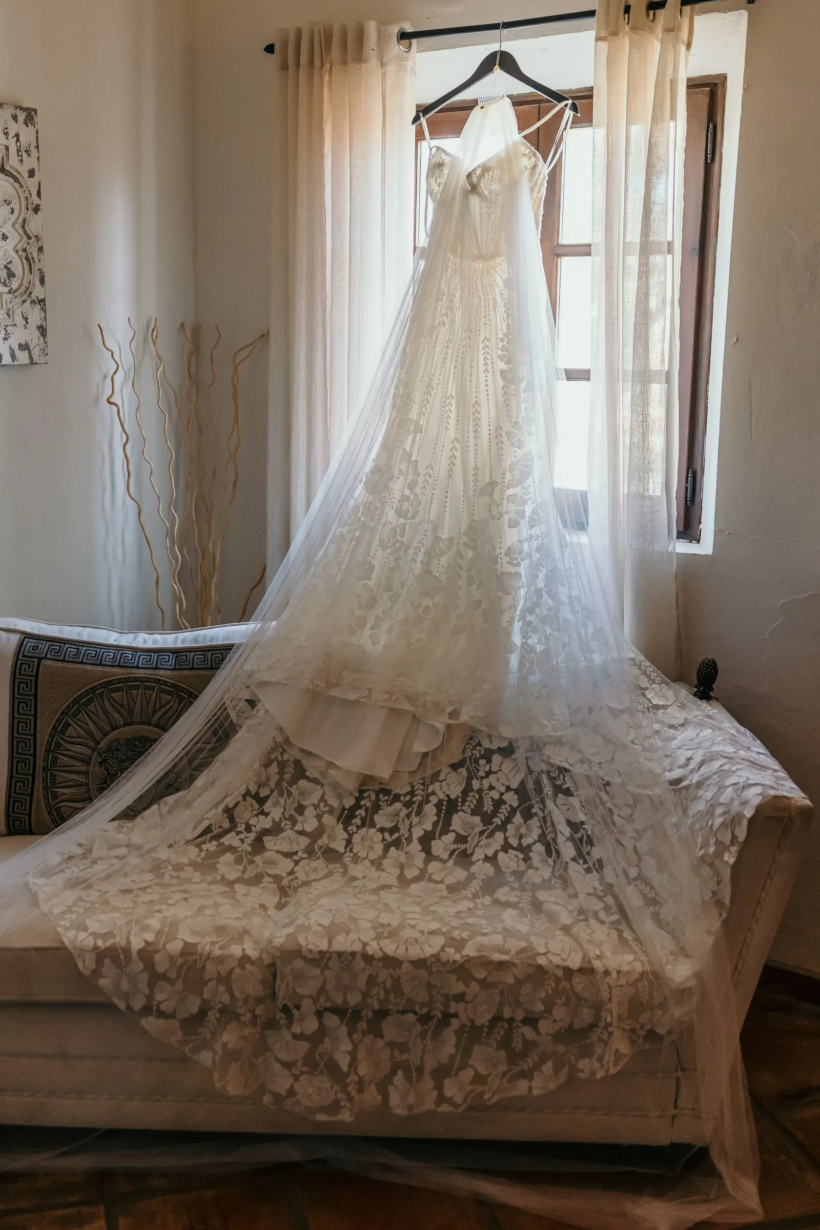 Wedding dress hanging by the window of the bridal suite at Hacienda San José, Mijas