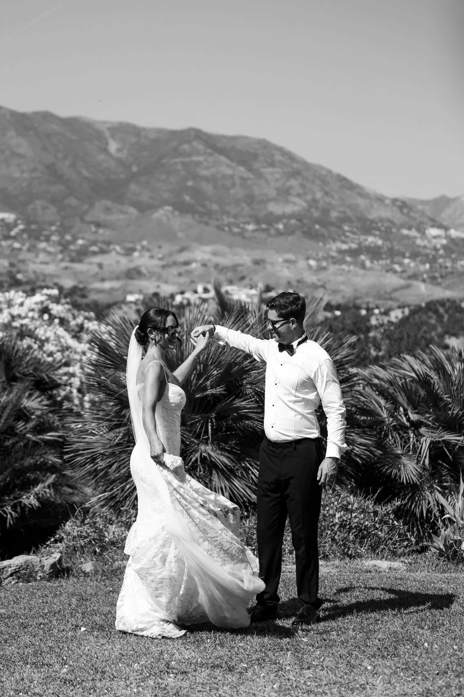 Black and white photo of the couple dancing on a hillside above Mijas