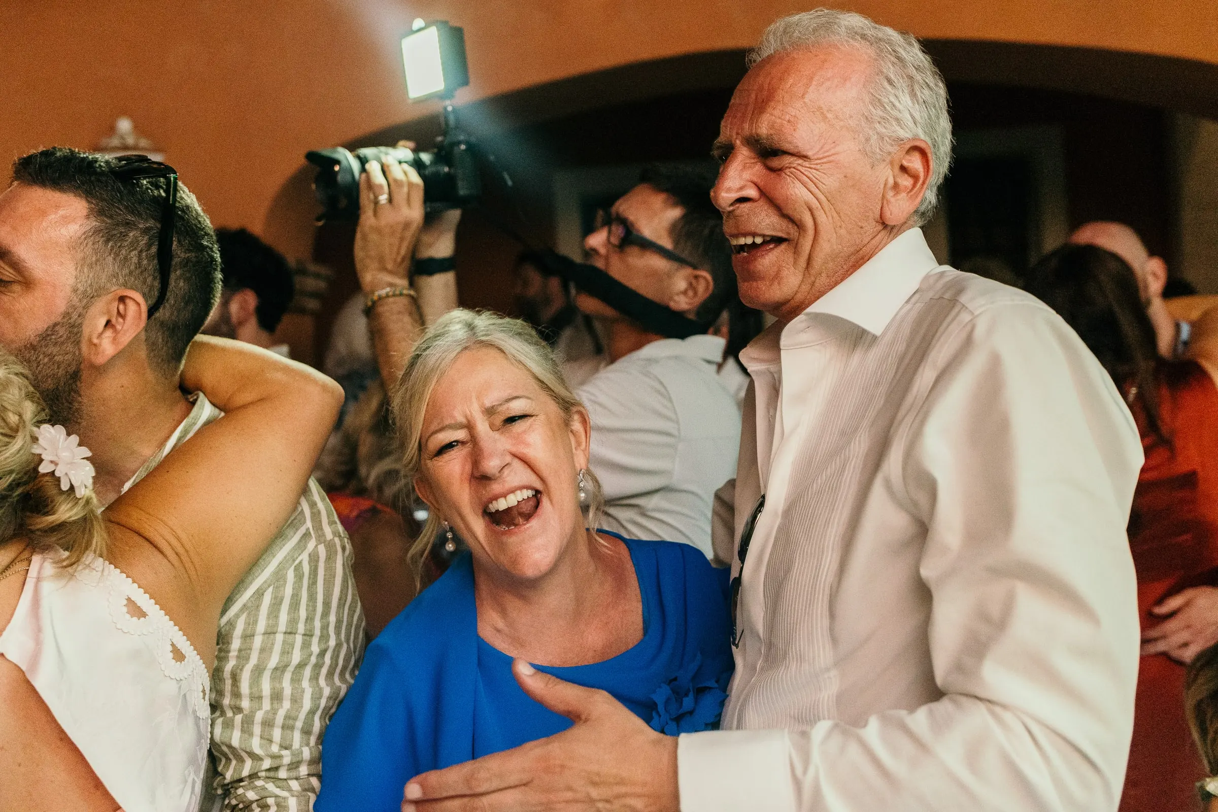 Guests dancing and laughing at the wedding party