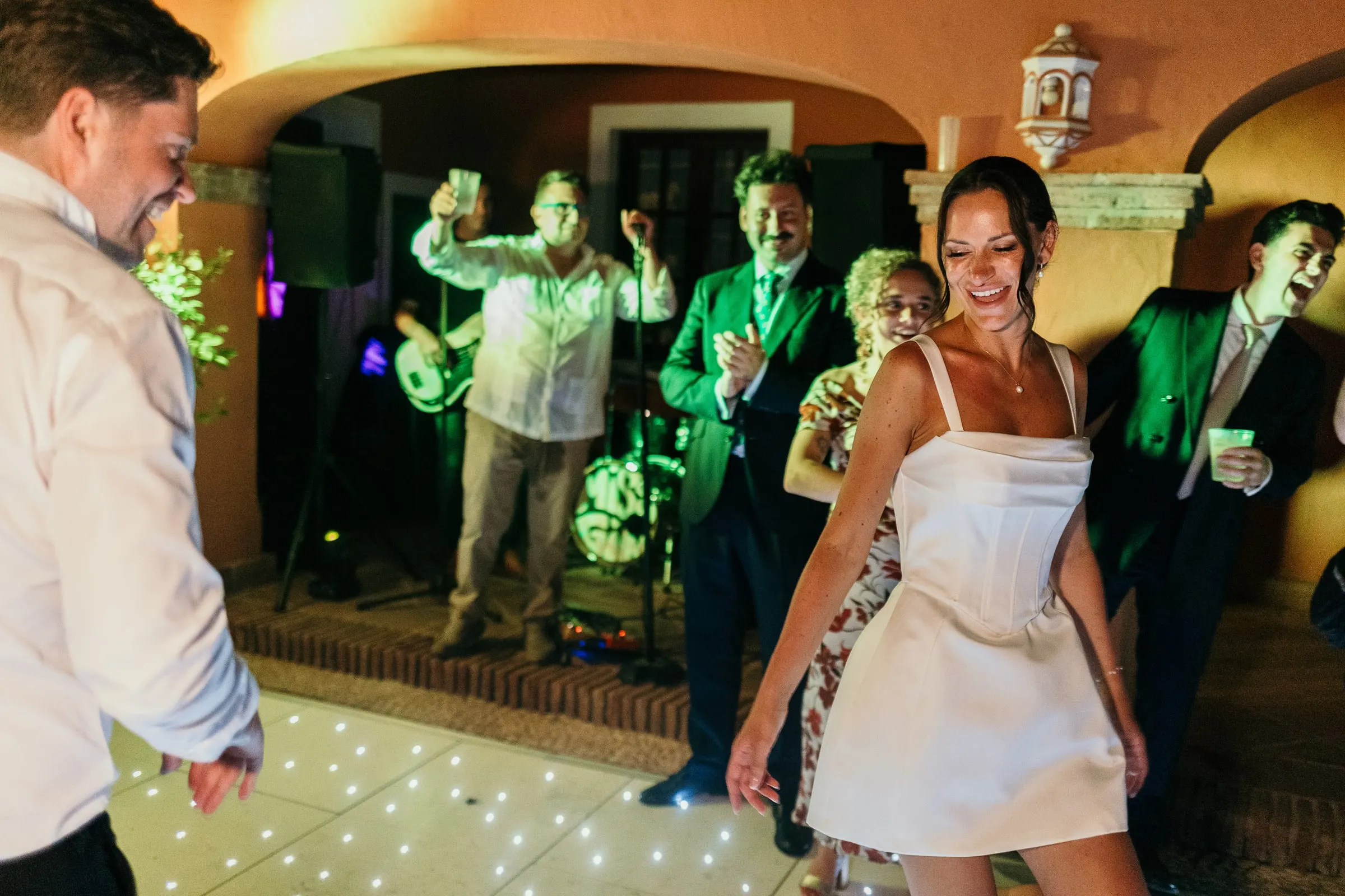 Bride dancing in a short party dress at the hacienda