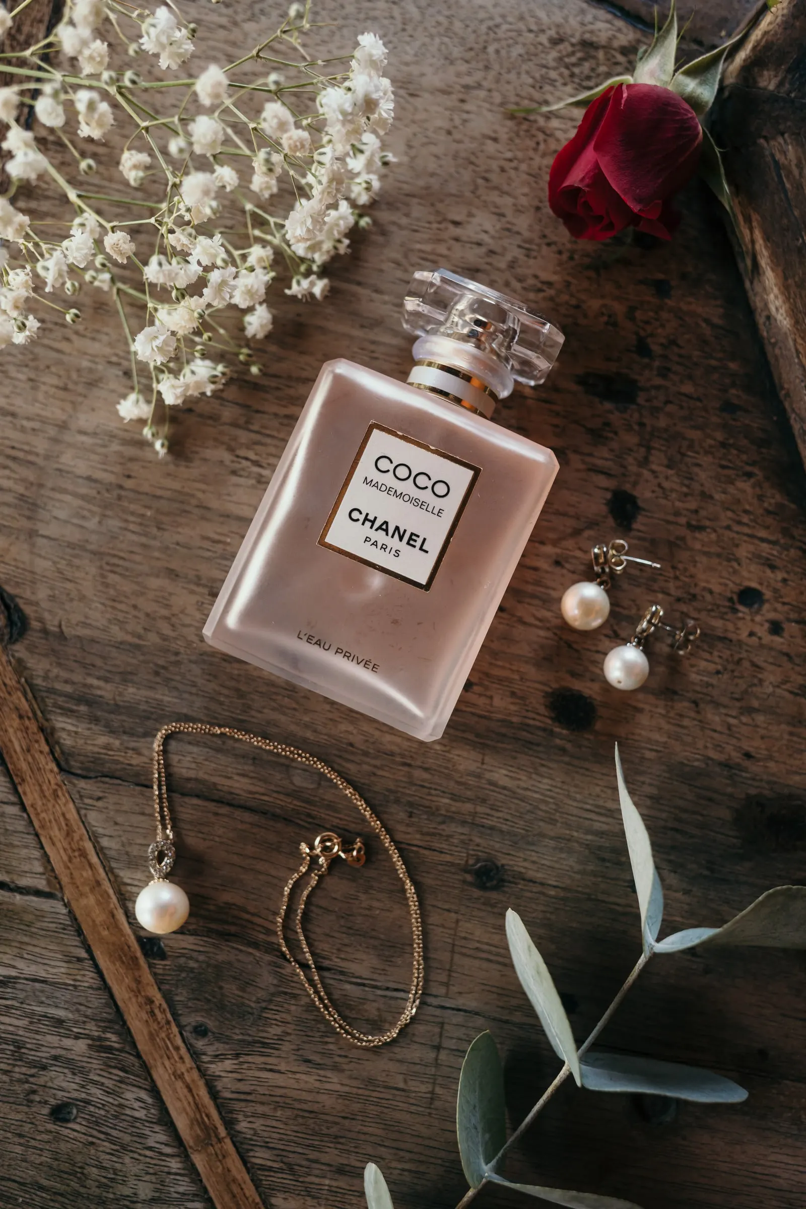 Bodegón con perfume, pendientes de perla, una pulsera, una rosa roja y paniculata, Hacienda San José, Mijas