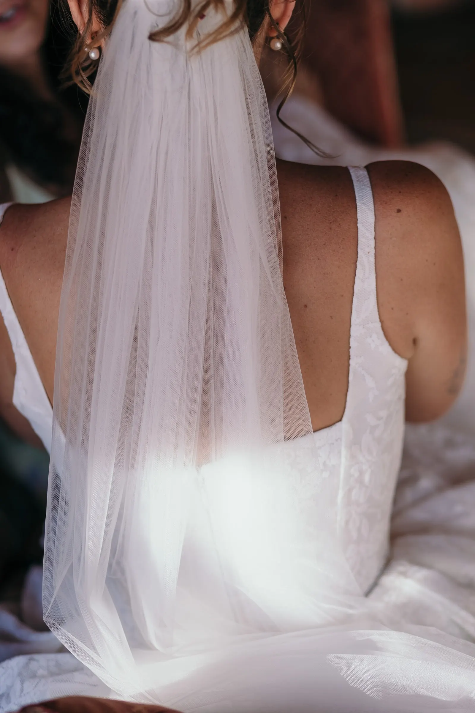 Close-up of the bride's back and sheer veil catching the light, Hacienda San José, Mijas