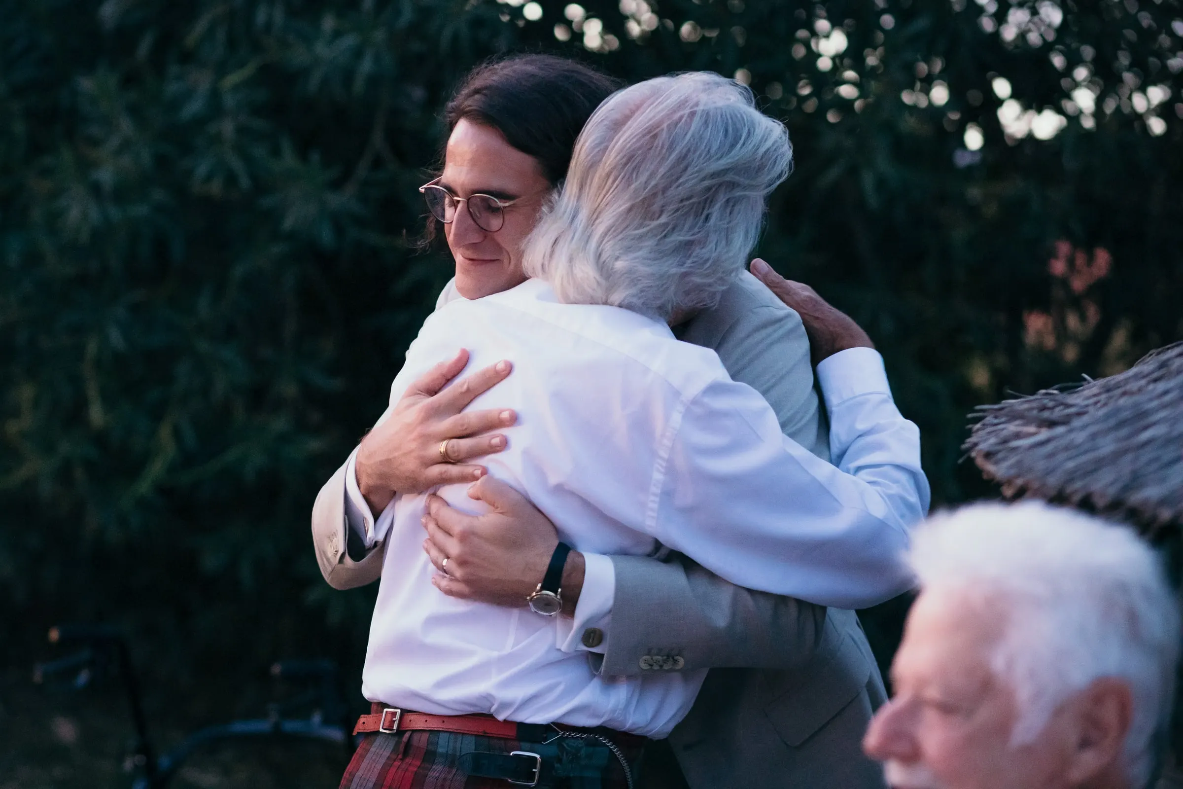 Groom hugging an older guest in a kilt after his speech at Hacienda San José, Mijas