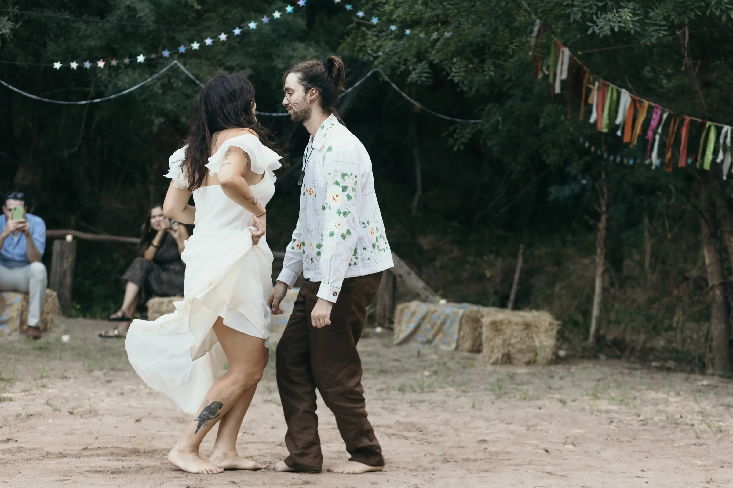 First dance on the sand under bunting and string lights in Jimera de Líbar