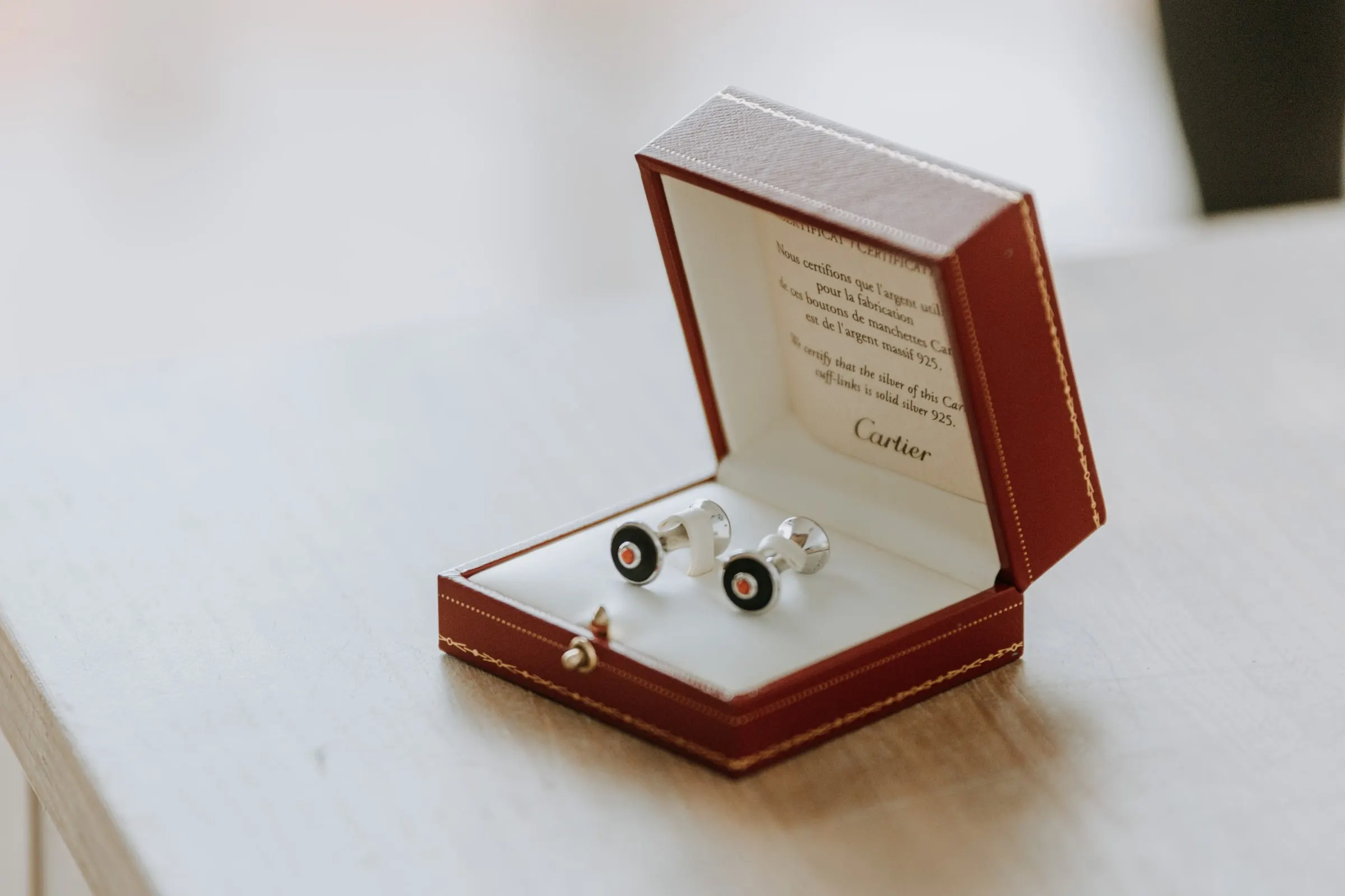 Silver cufflinks in a red box on the groom's table, Sotogrande
