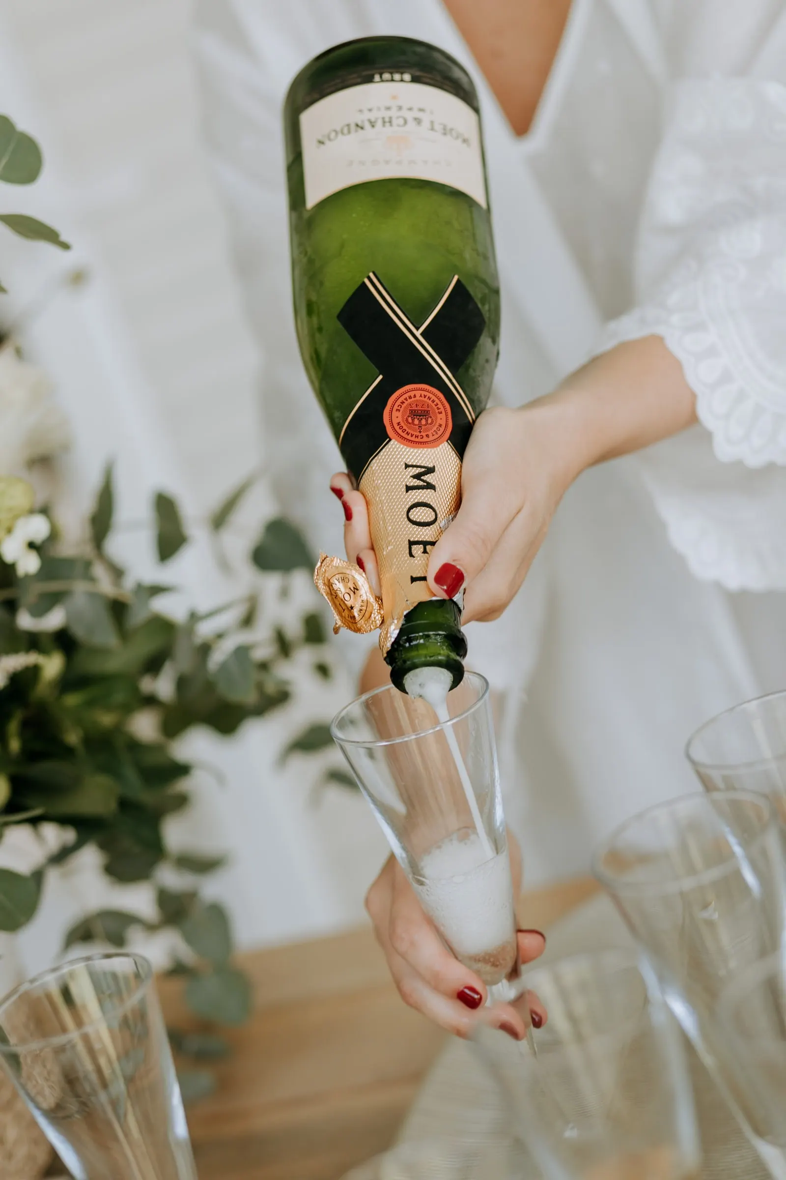 Champagne being poured into glasses on the wedding morning
