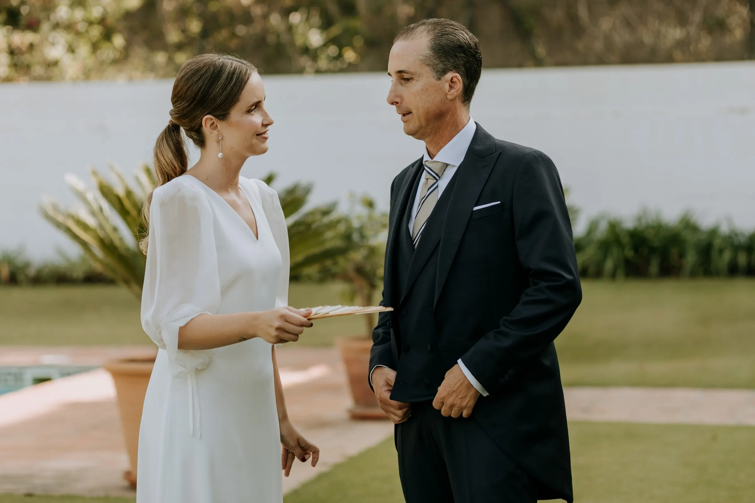 Bride and her father talking in the garden before leaving for the church in Sotogrande