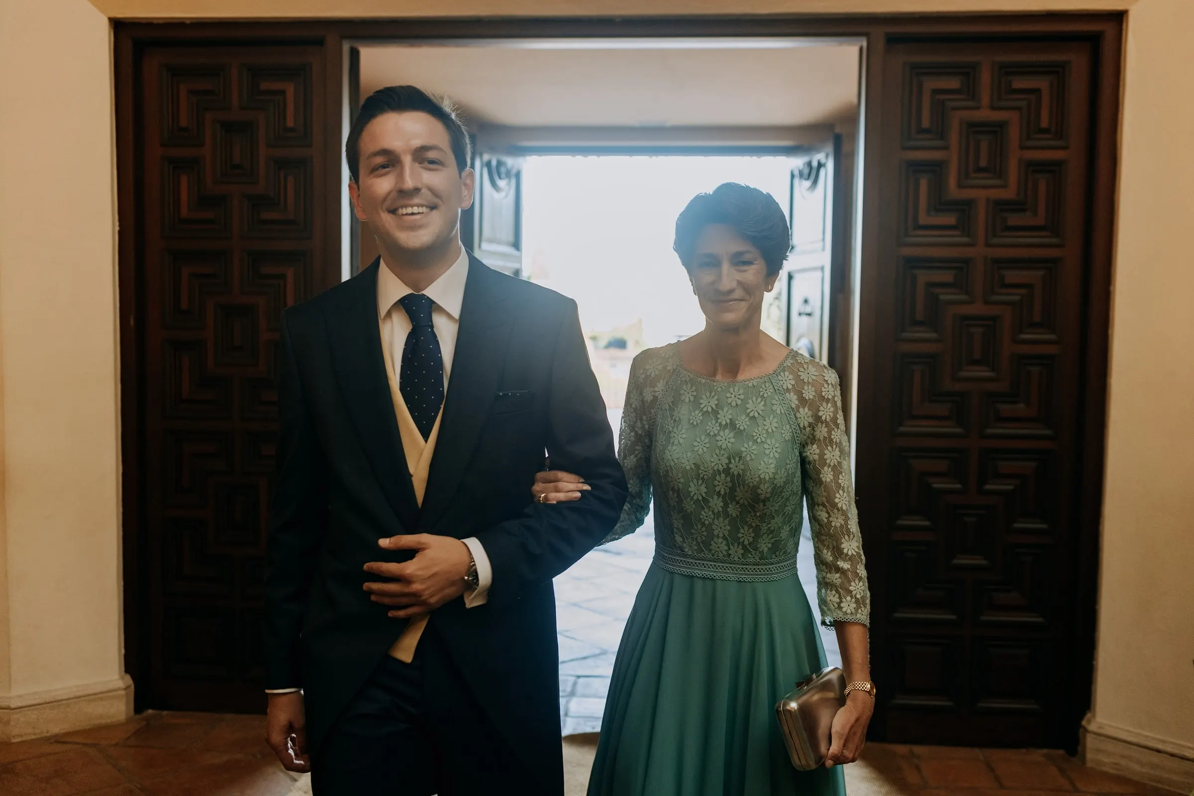 Groom and a woman in green waiting at the door of the church of Nuestra Señora de la Merced, Sotogrande