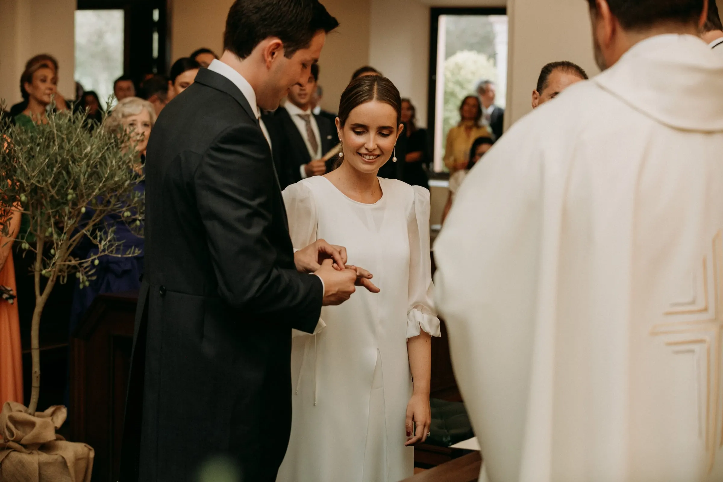 Groom placing the ring on the bride's finger