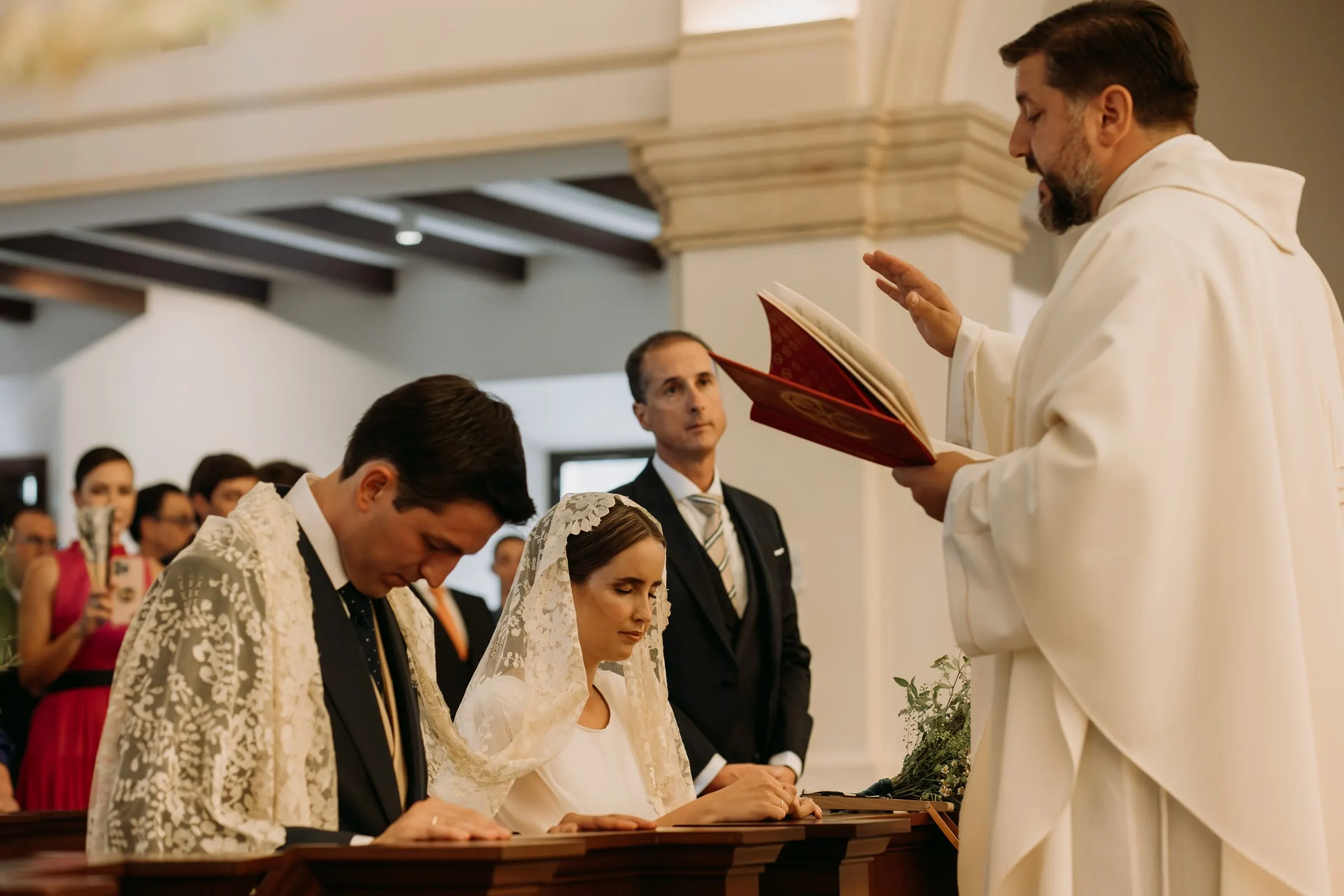 Bride and groom signing the register at the altar