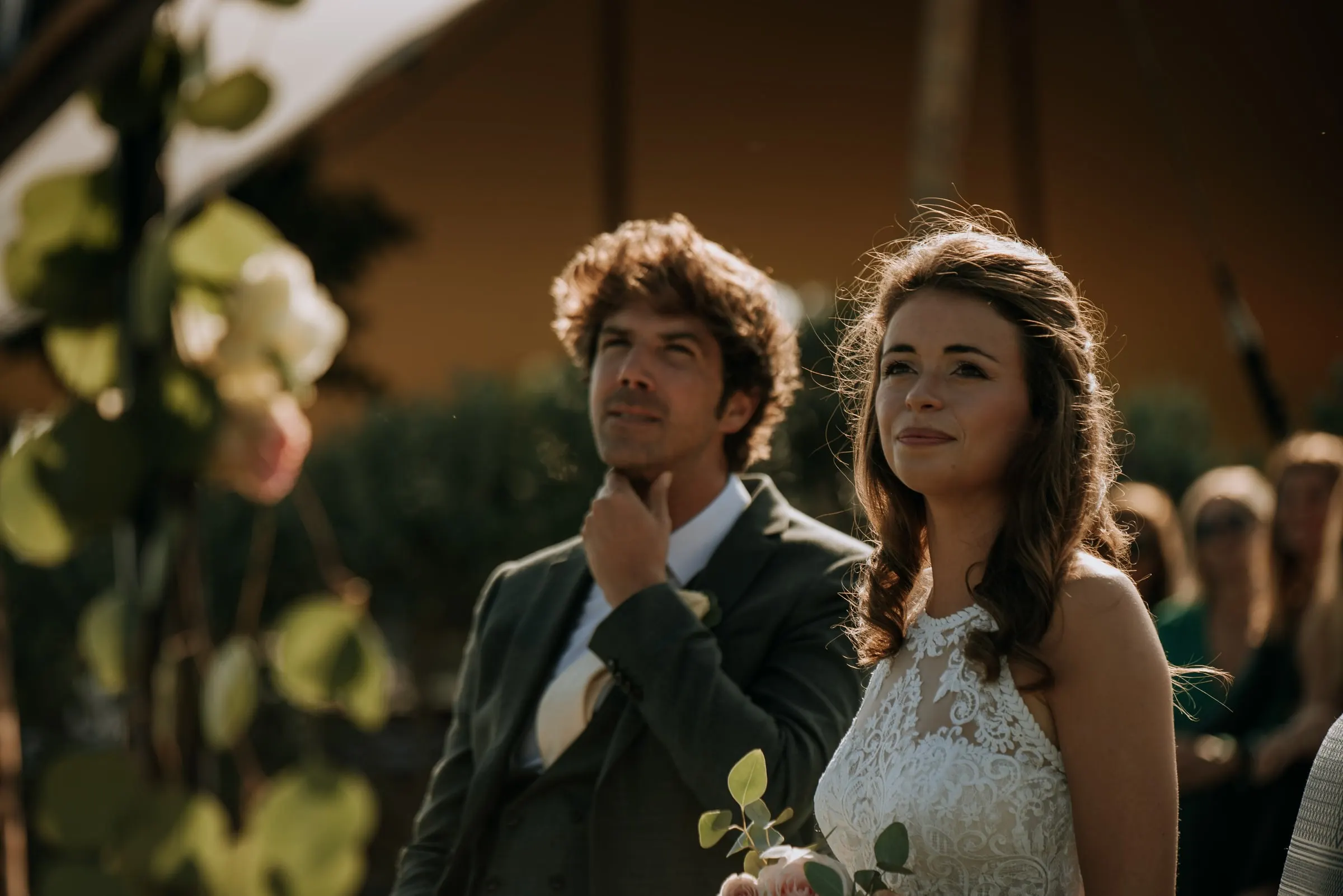 Los novios escuchan pensativos durante la ceremonia, entre flores, Trocadero, Sotogrande