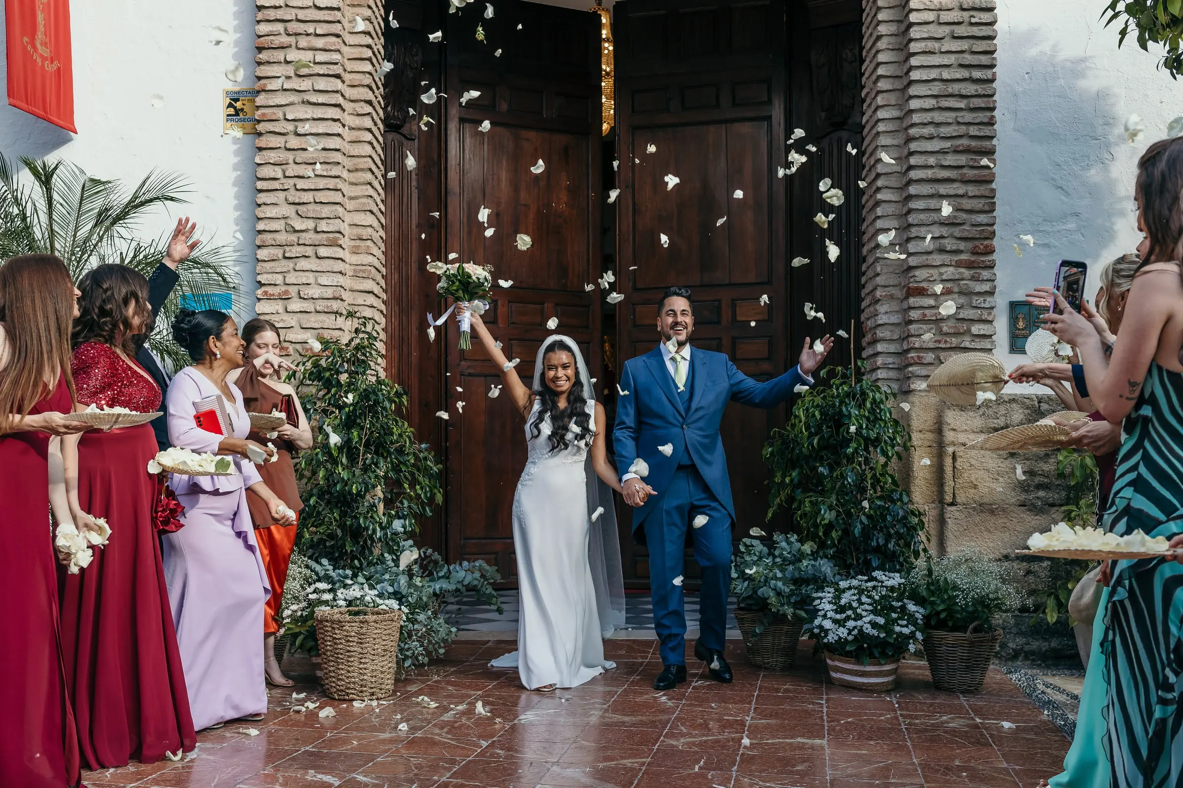 Los recién casados salen de la iglesia bajo una lluvia de pétalos blancos, Marbella